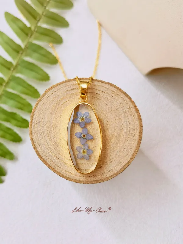 Forget Me Not Golden Oval Pendant Natural Resin Necklace sold by Like My Choice