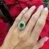 Oval Cut Emerald with Sunburst Halo sold by LINDSEY LEIGH JEWELRY