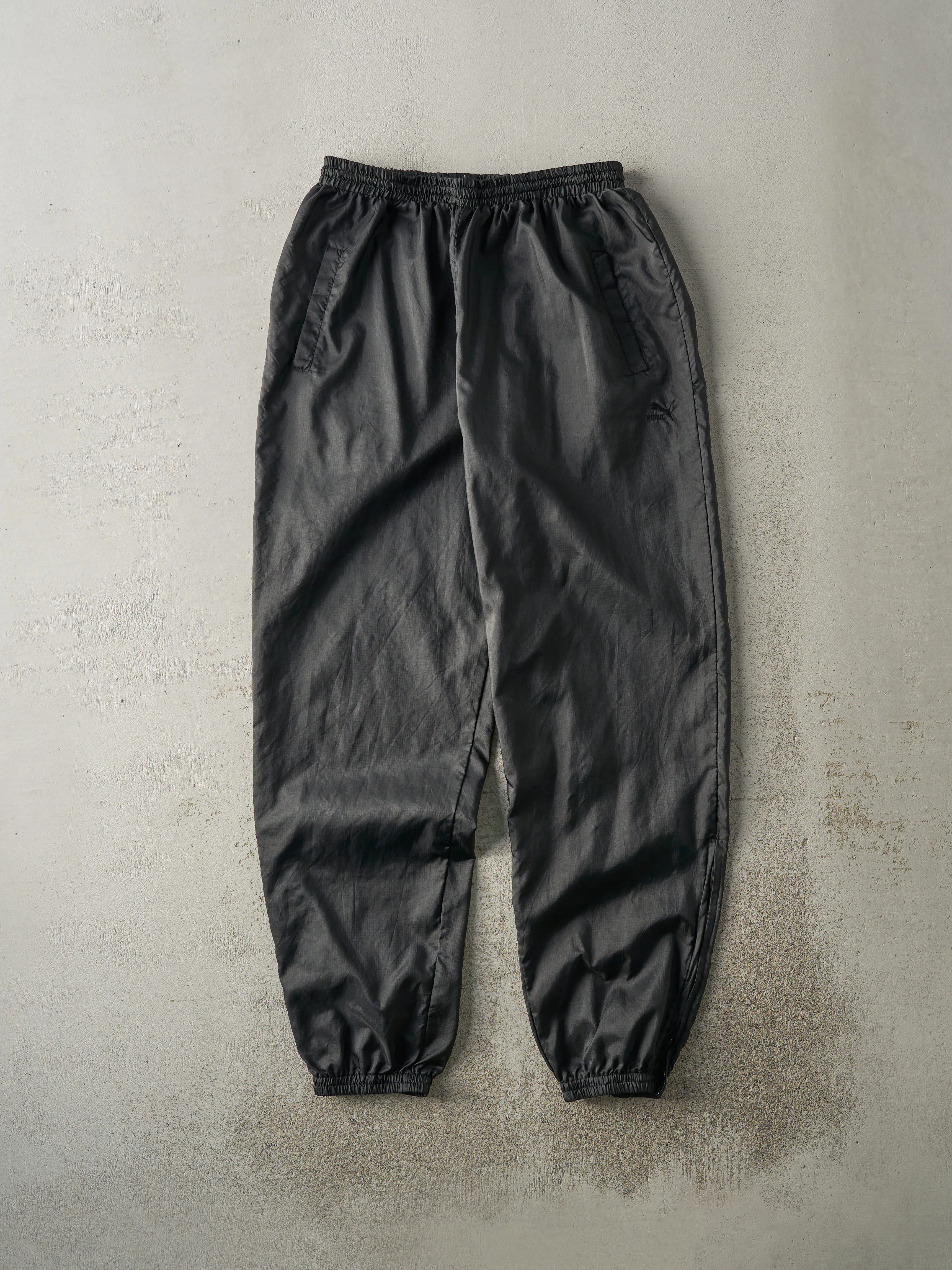 Vintage 90s Black Puma Tonal Logo Windbreaker Pants (30x31) sold by Rebalance Vintage