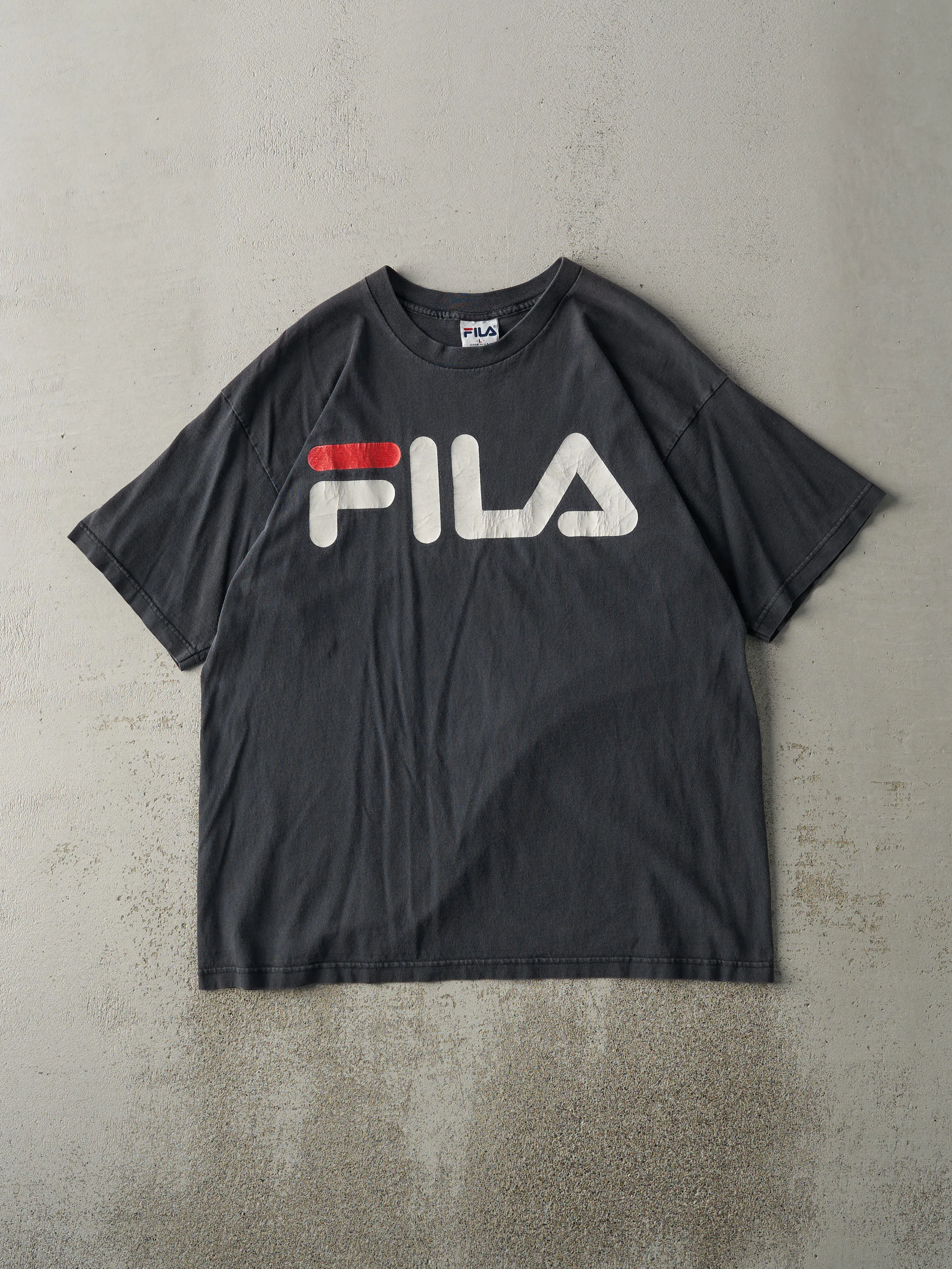 Vintage 90s Faded Black Fila Tee (L) sold by Rebalance Vintage