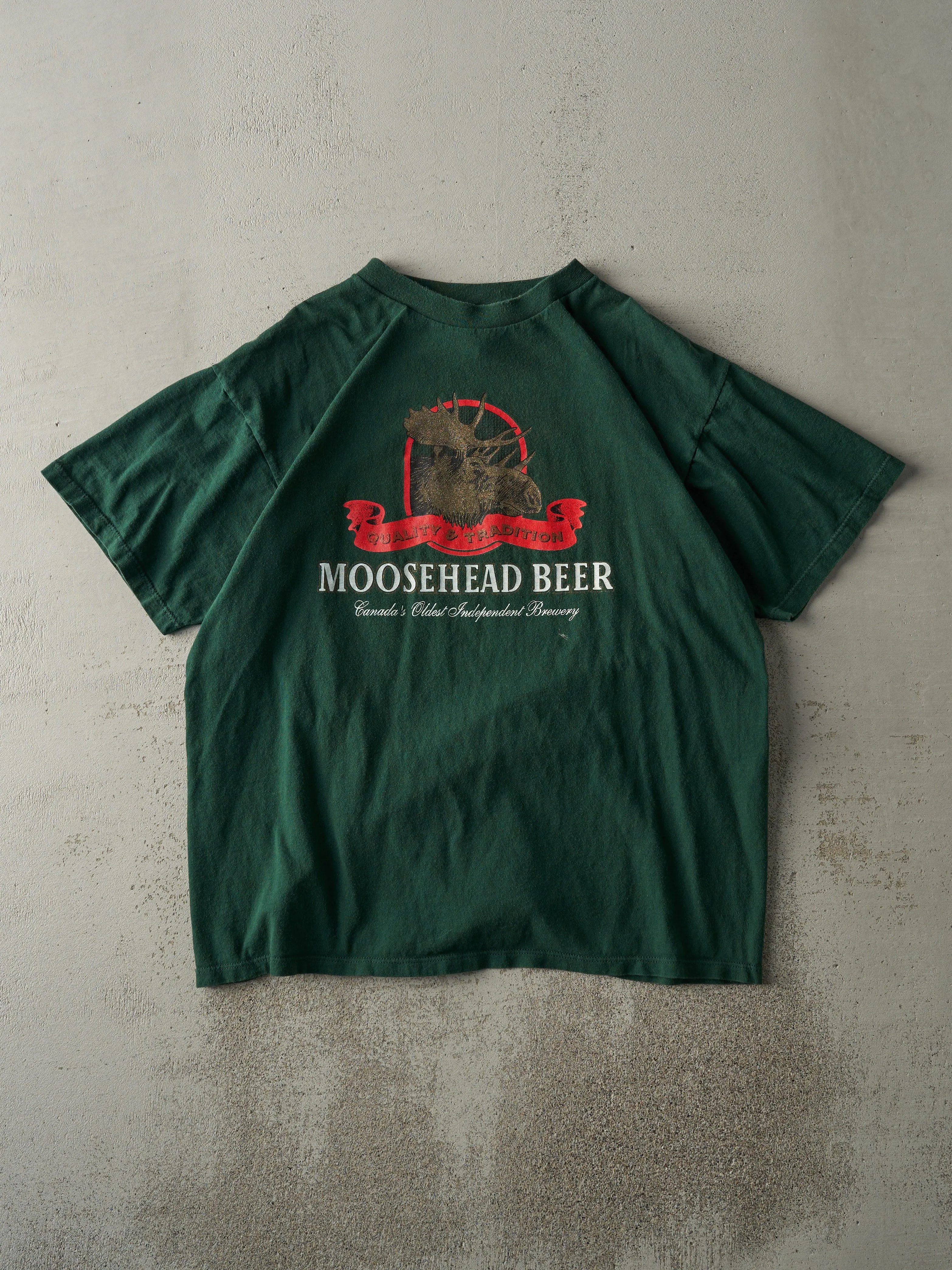 Vintage 90s Forest Green Moosehead Beer Tee (L) sold by Rebalance Vintage