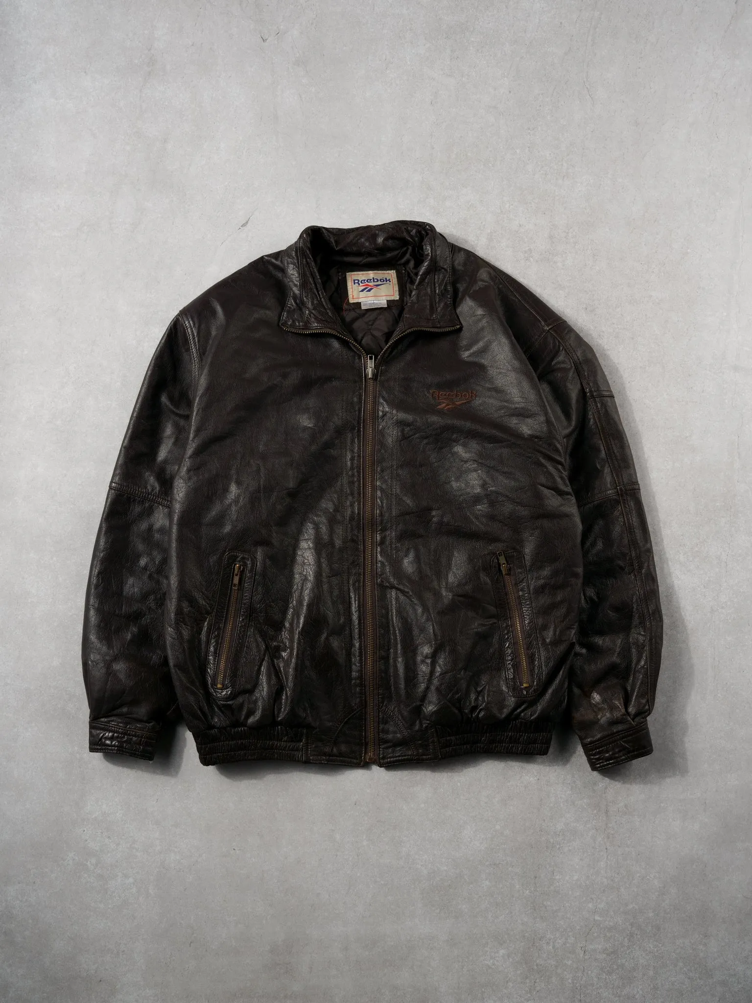 Vintage 90s Dark Brown Reebok Leather Jacket (L) sold by Rebalance Vintage