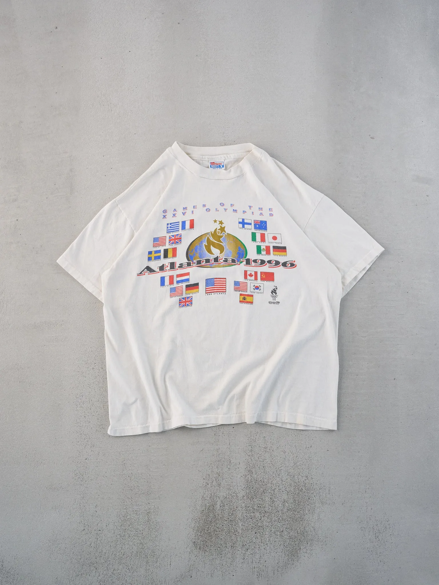 Vintage 96' White Single Stitched Atlanta International Olympics Tee (L) sold by Rebalance Vintage