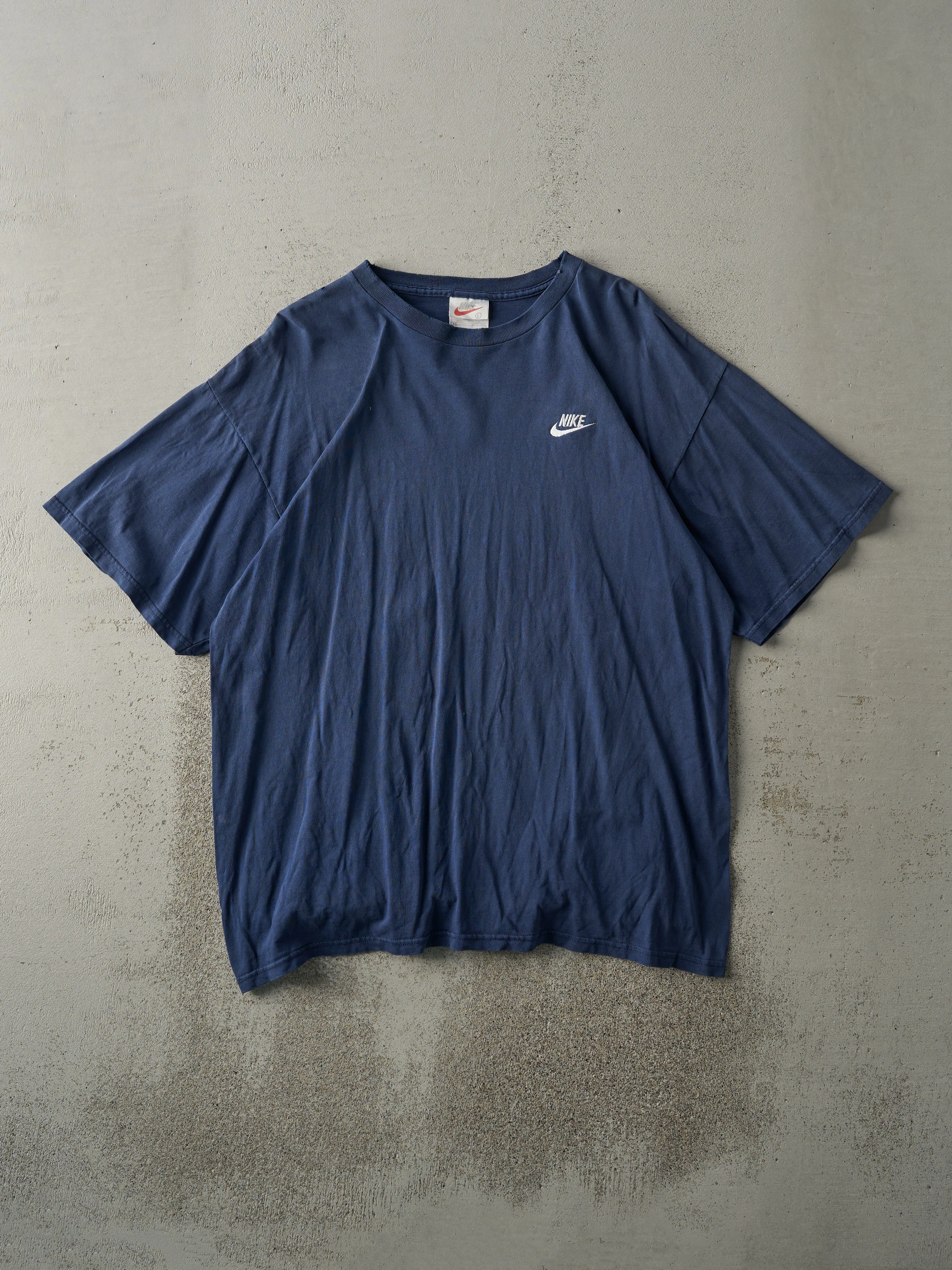 Vintage 90s Navy Blue Nike Embroidered Logo Tee (M) sold by Rebalance Vintage