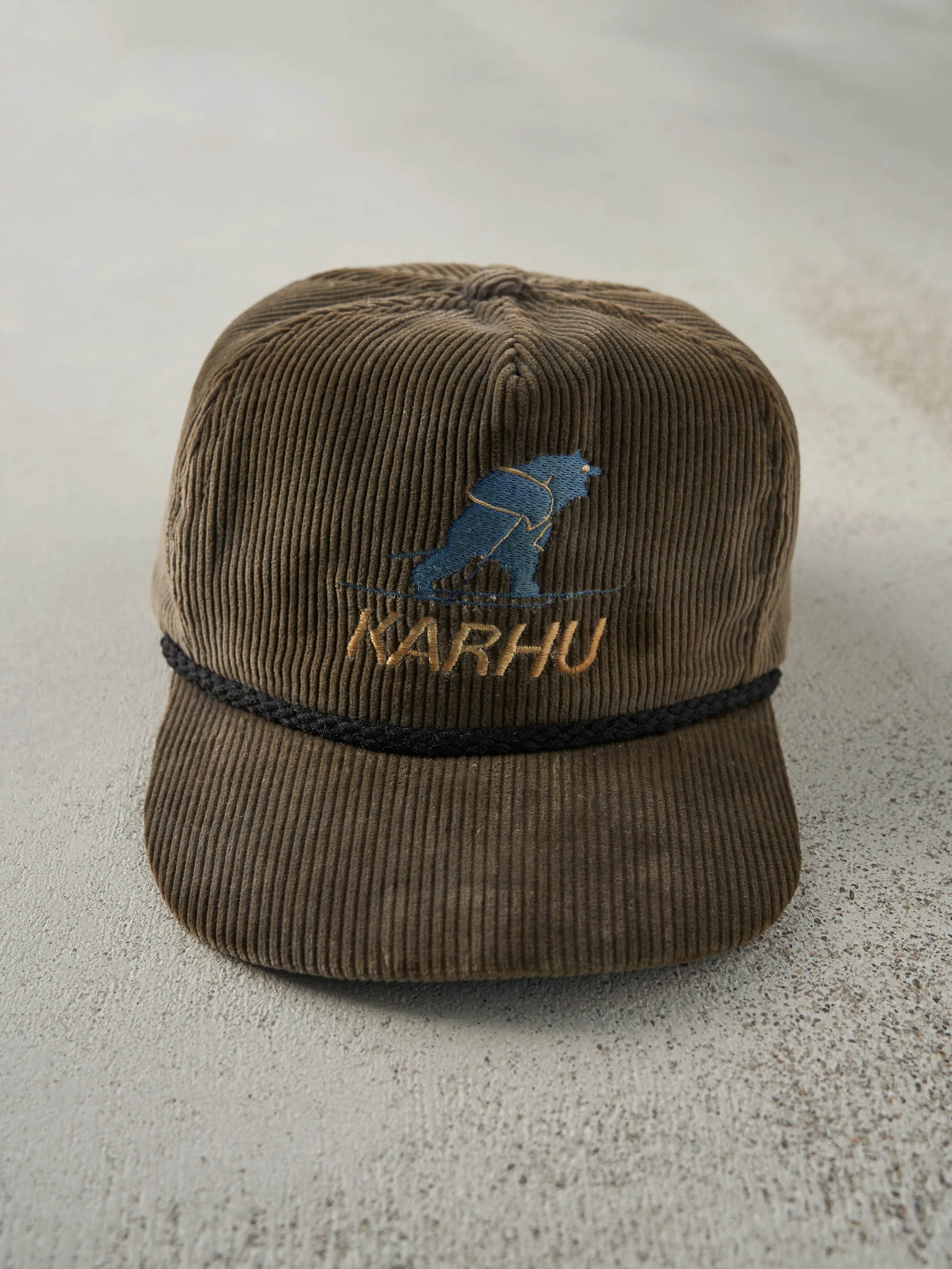 Vintage 80s Brown Embroidered Karhu Corduroy Leather Strap Back Hat sold by Rebalance Vintage