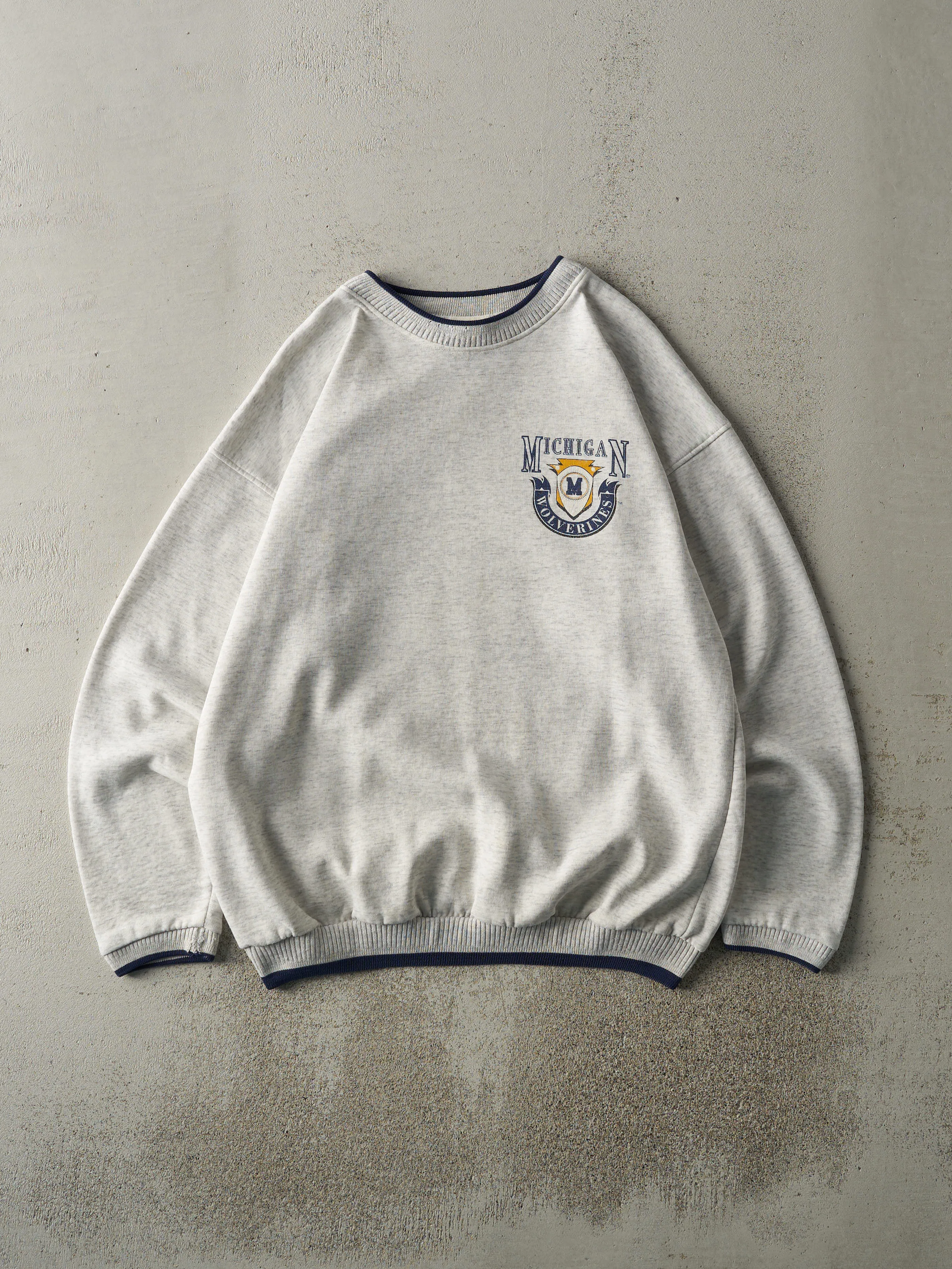 Vintage 90s Heather Grey & Navy University of Michigan Wolverines Crewneck (L) sold by Rebalance Vintage
