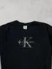 Vintage 90s Washed Black Clavin Klein Graphic Tee (M) sold by Rebalance Vintage