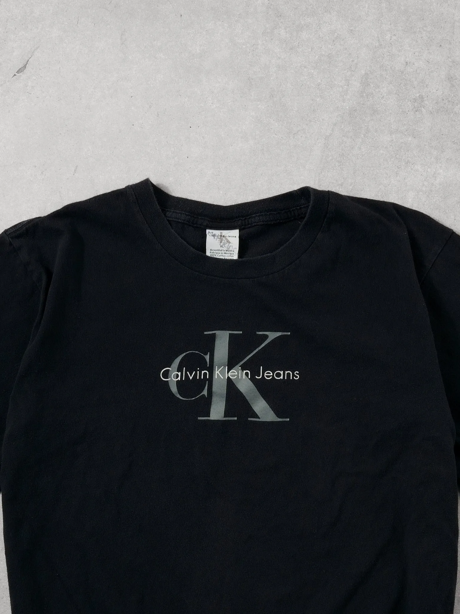 Vintage 90s Washed Black Clavin Klein Graphic Tee (M) sold by Rebalance Vintage product image thumbnail 2