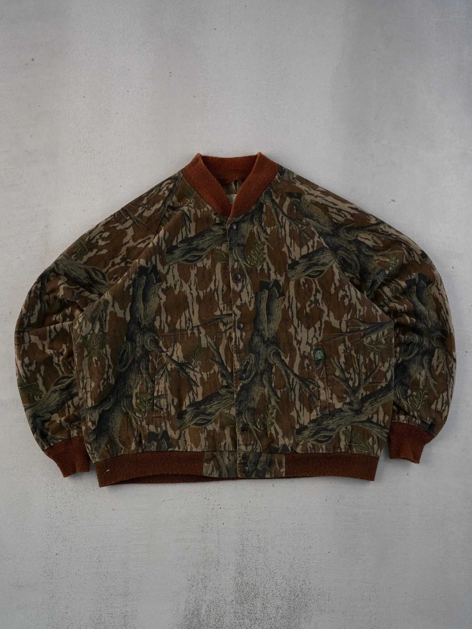 Vintage 90s Green Mossy Oak Realtree Camo Bomber Jacket (XL) sold by Rebalance Vintage
