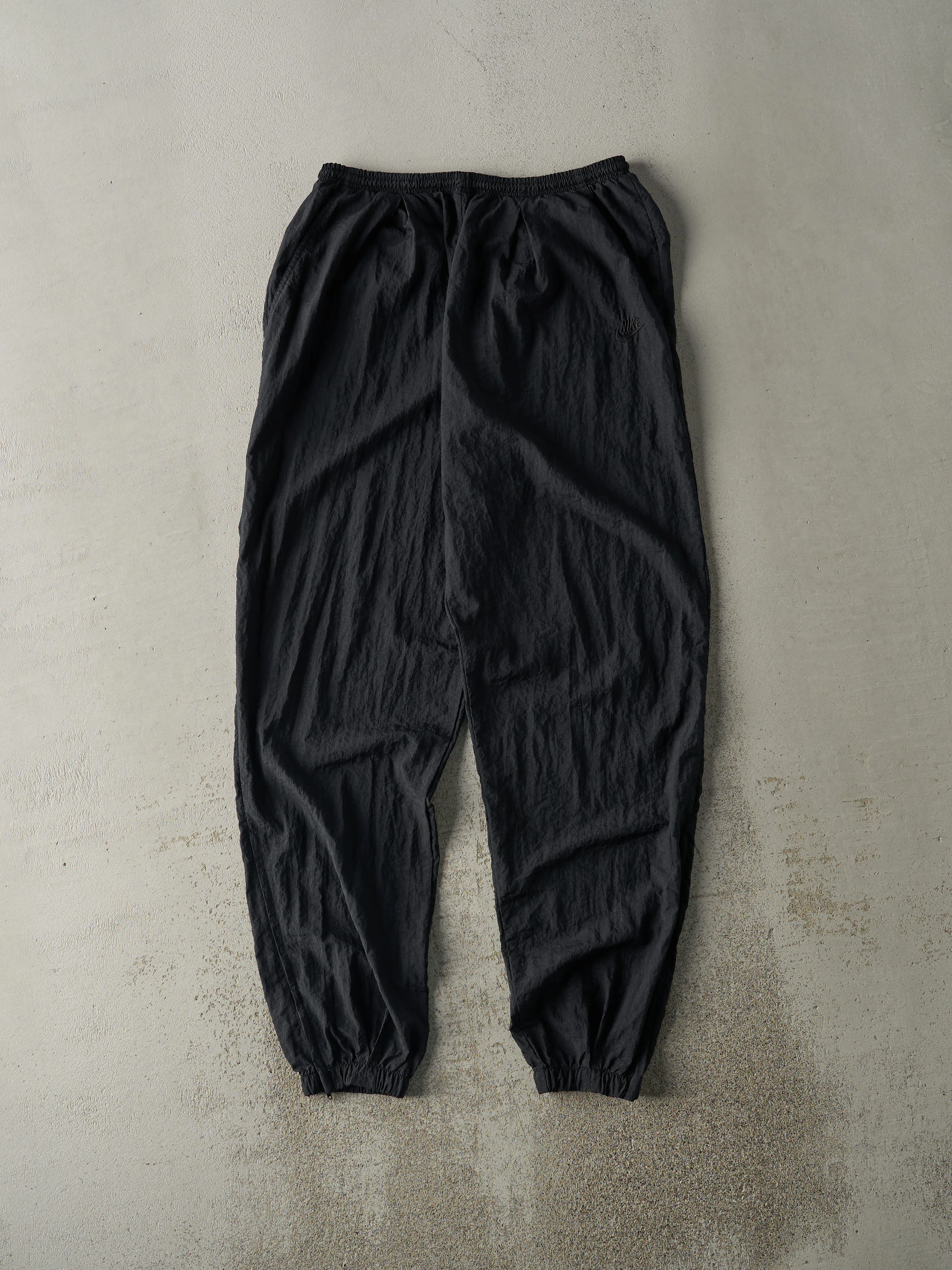 Vintage 90s Black Nike Embroidered Windbreaker Pants (30x32) sold by Rebalance Vintage