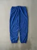 Vintage 90s Blue Champion Embroidered Logo Nylon Windbreaker Pants (36x32.5) sold by Rebalance Vintage