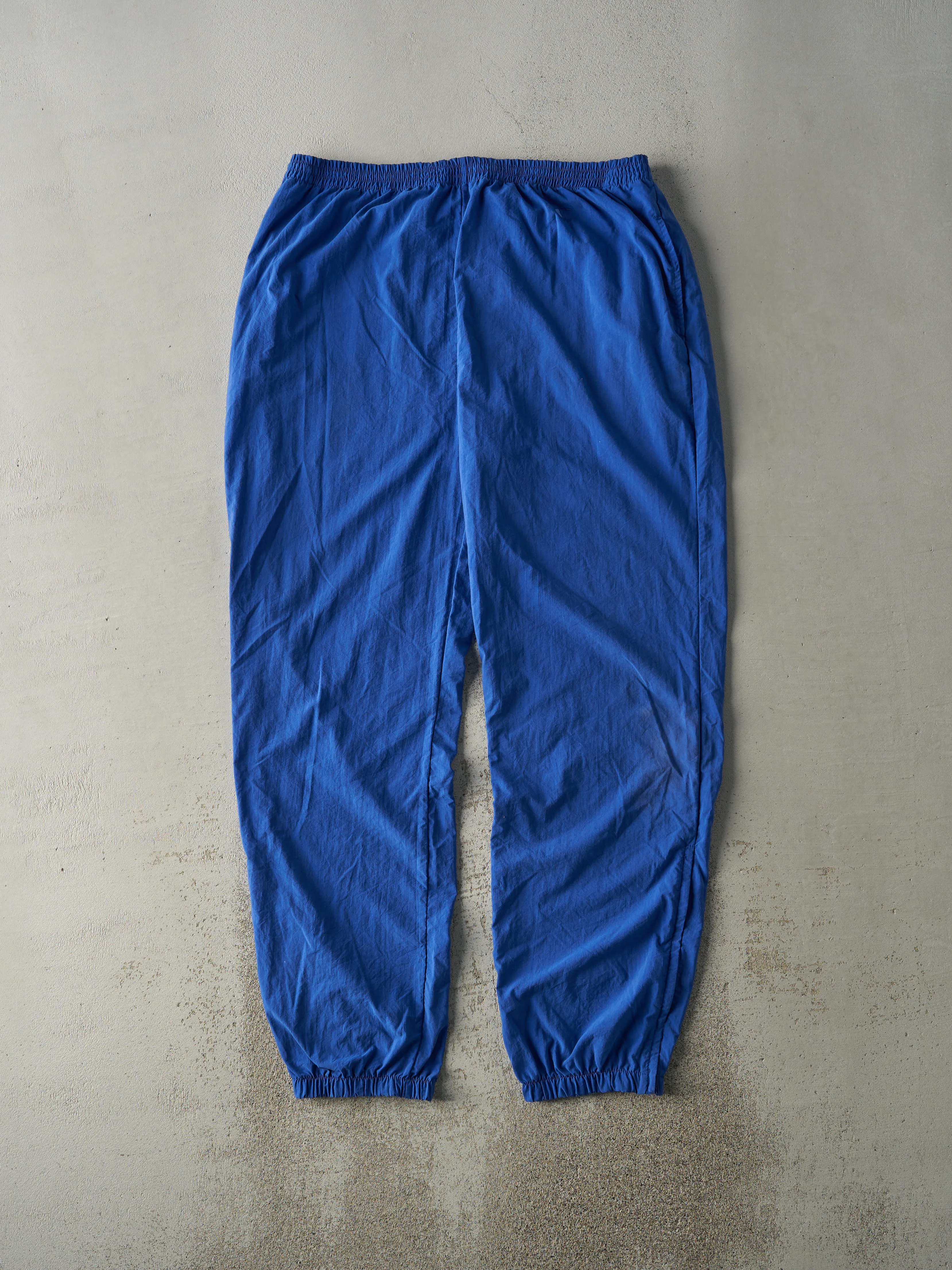 Vintage 90s Blue Champion Embroidered Logo Nylon Windbreaker Pants (36x32.5) sold by Rebalance Vintage