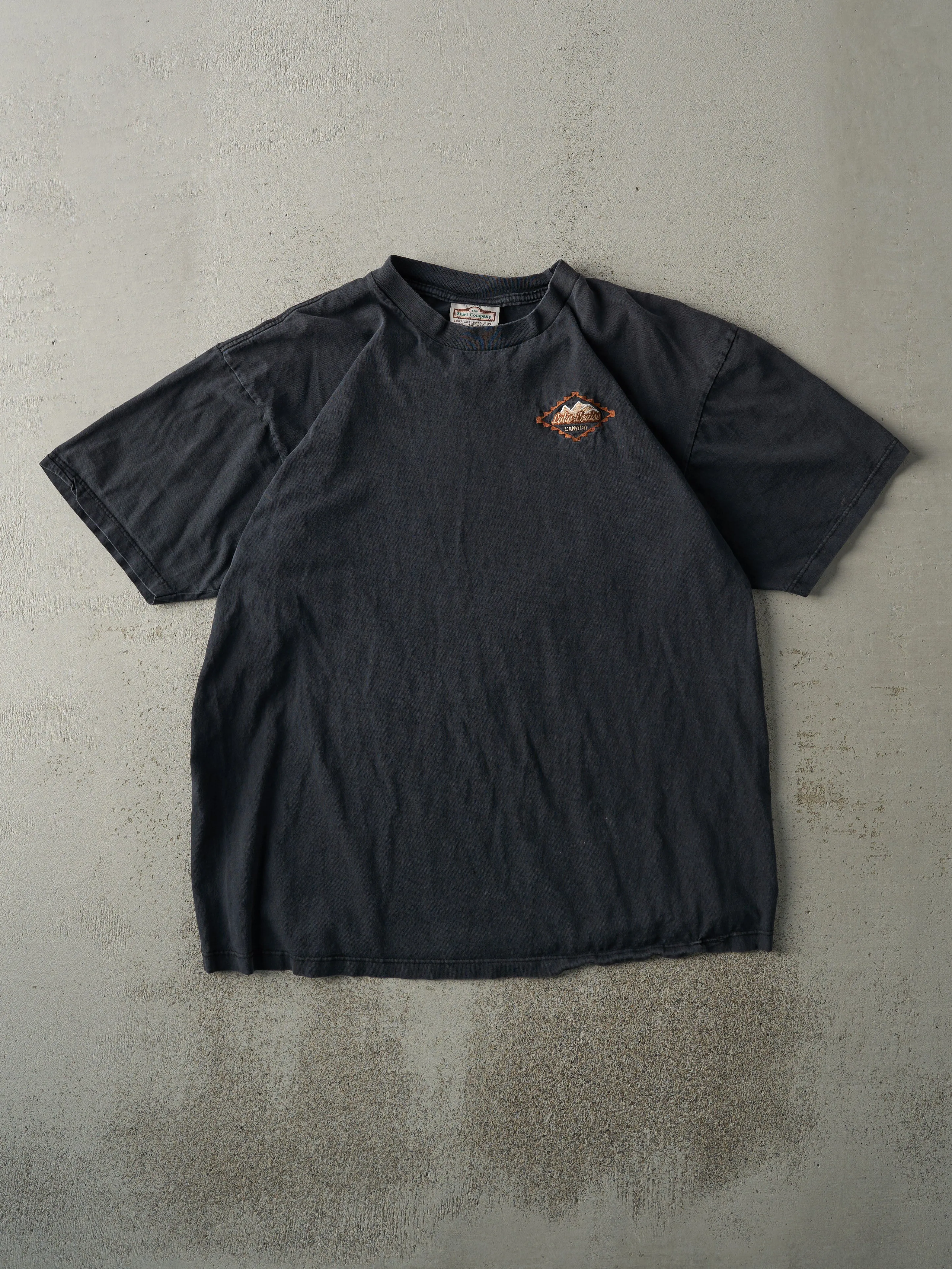 Vintage 90s Faded Black Embroidered Lake Louise Tee (L) sold by Rebalance Vintage