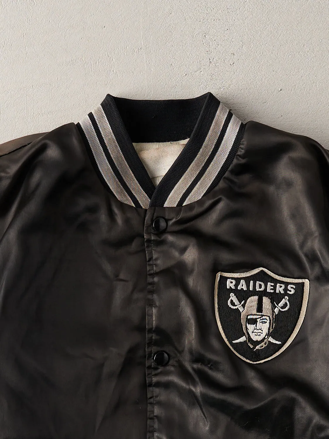 Vintage 90s Black Raiders Satin Varsity Jacket (L) sold by Rebalance Vintage product image thumbnail 2