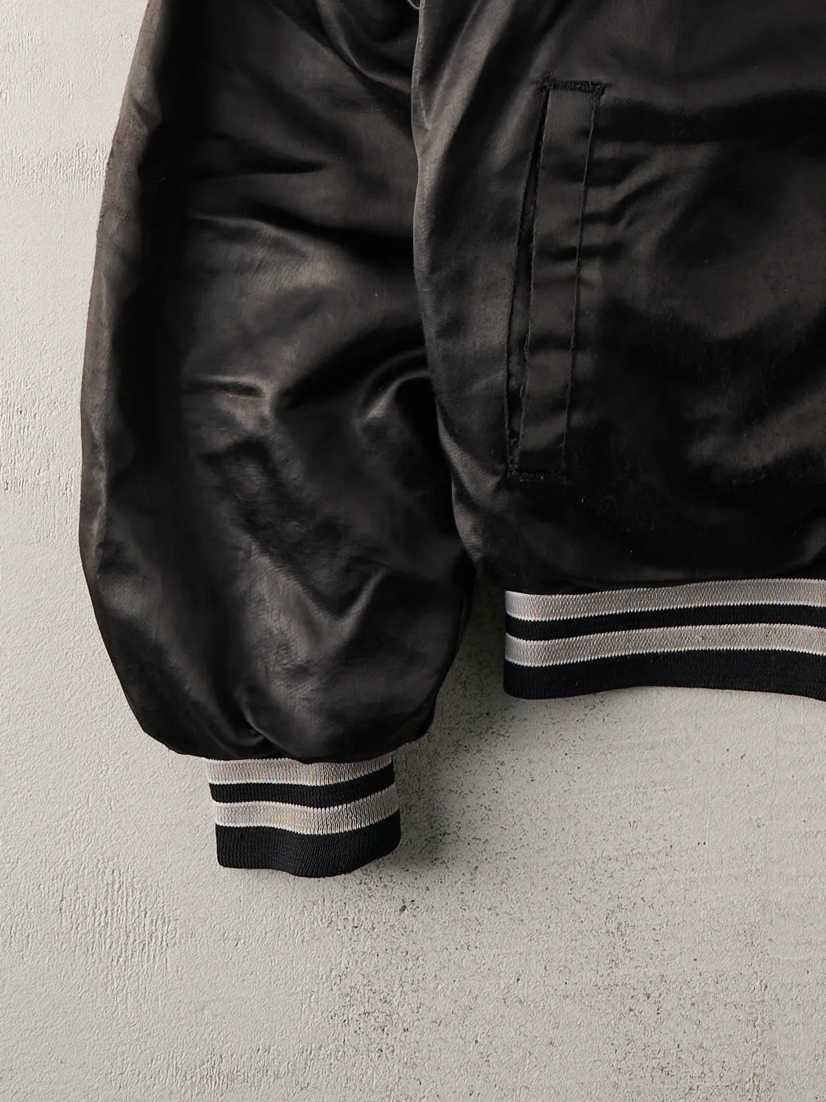 Vintage 90s Black Raiders Satin Varsity Jacket (L) sold by Rebalance Vintage product image thumbnail 3