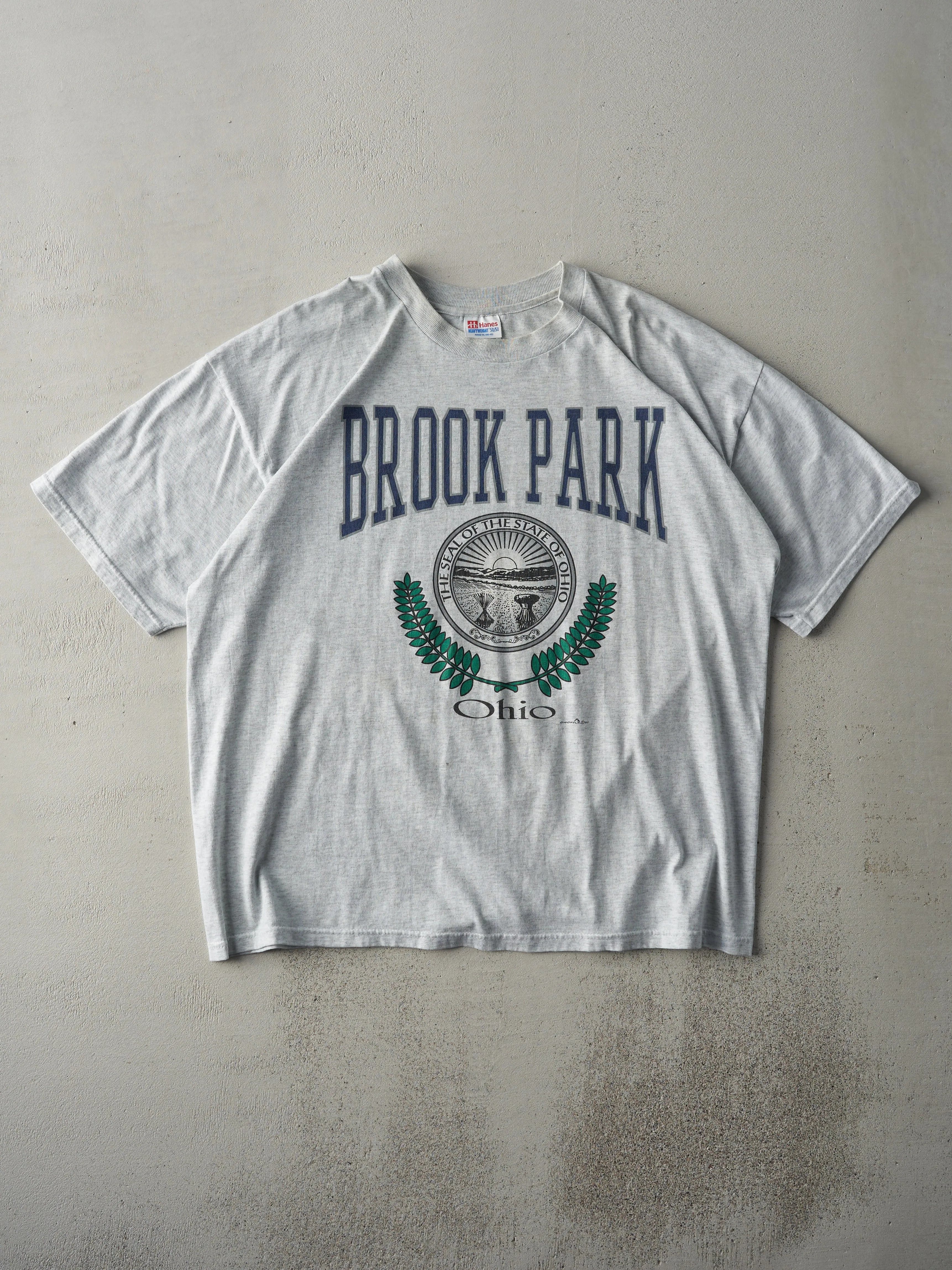 Vintage 97' Heather Grey Brook Park Ohio Tee (L) sold by Rebalance Vintage