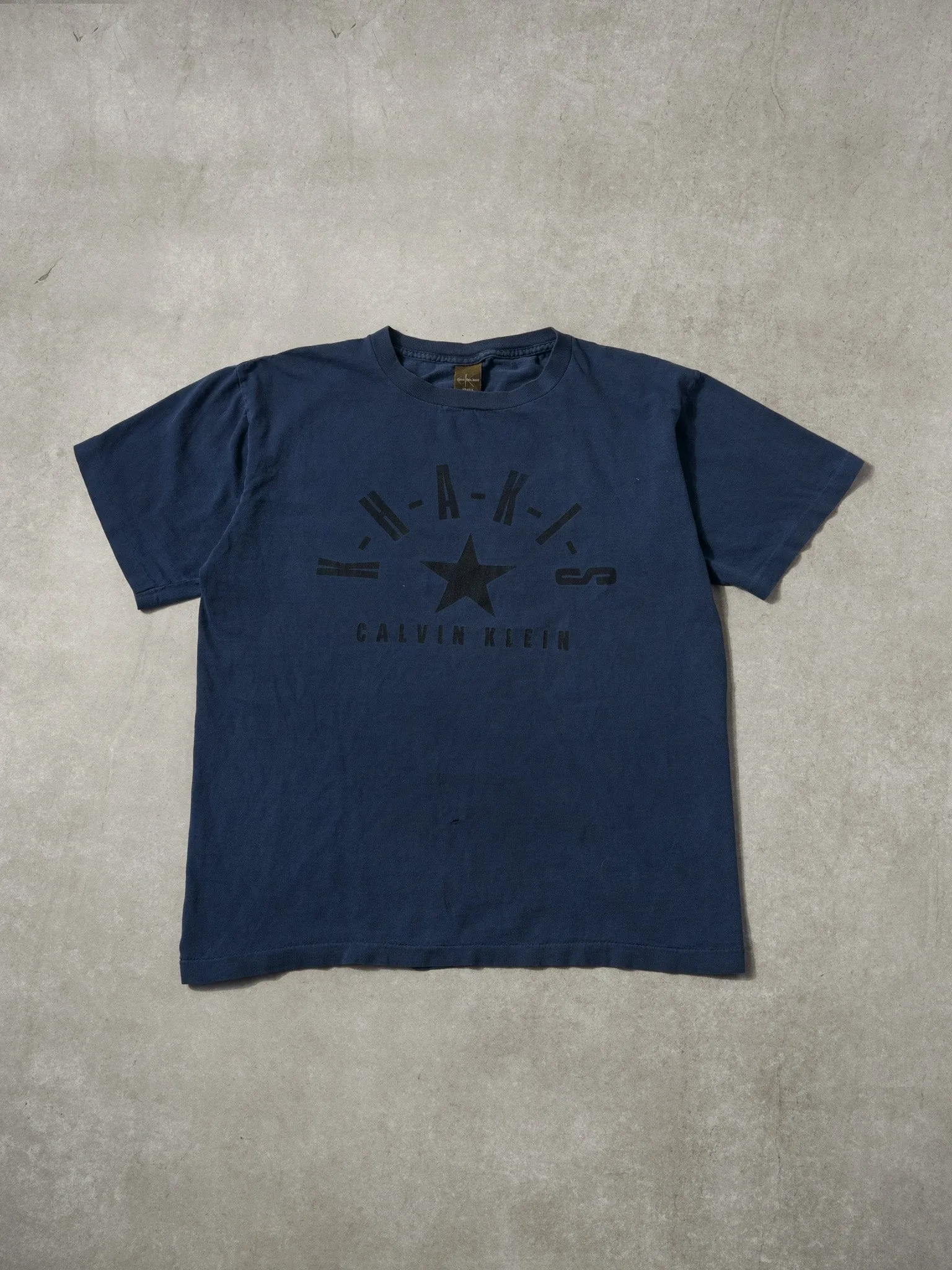 Vintage 90s Navy Blue Calvin Klein Khakis Jeans Graphic Tee (M) sold by Rebalance Vintage