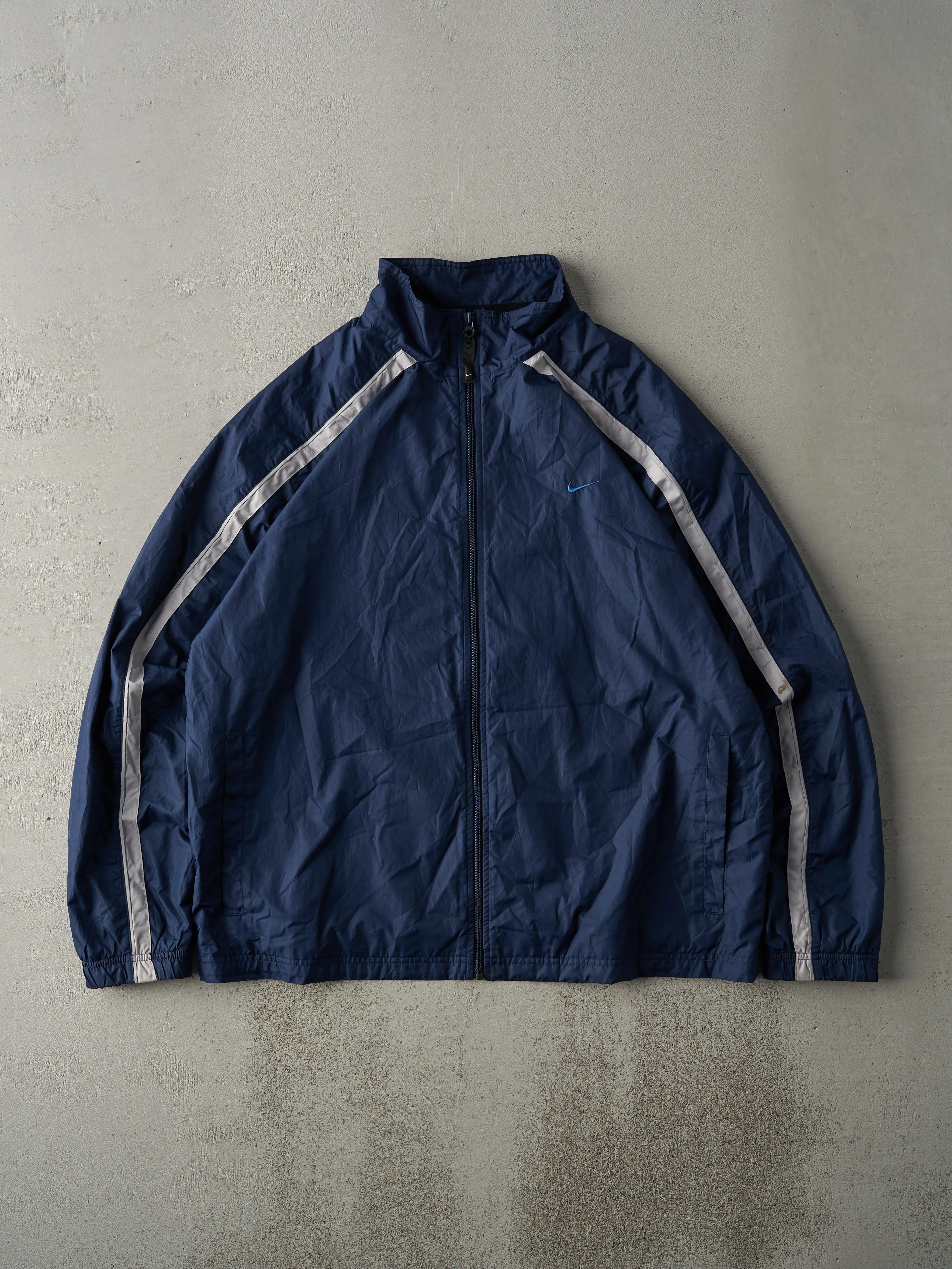Vintage Y2K Navy Blue Reflective Stripe Nike Embroidered Windbreaker Jacket (L) sold by Rebalance Vintage