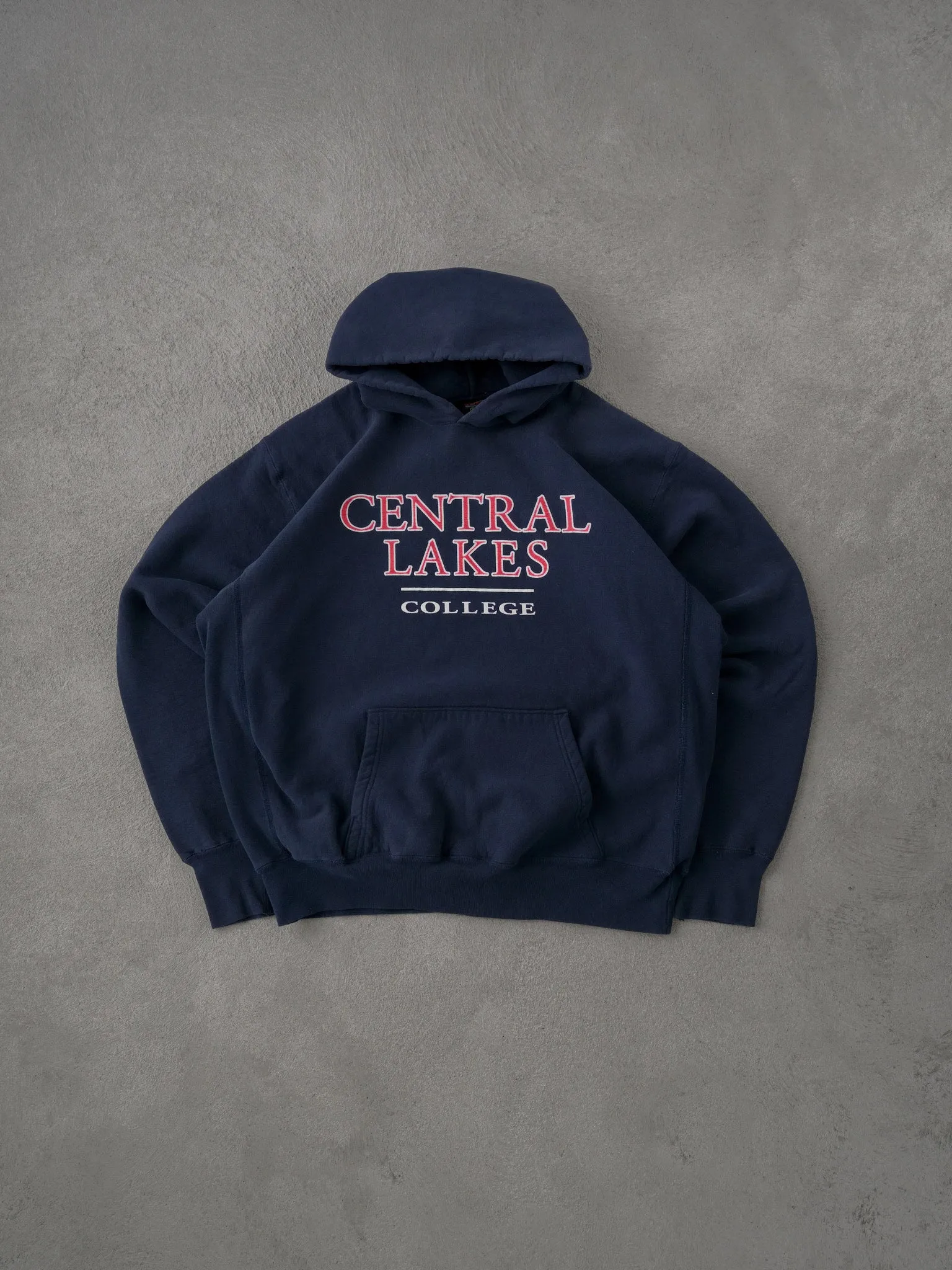 Vintage 90s Navy Blue Central Lakes College Hoodie (XL) sold by Rebalance Vintage