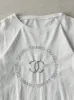 Vintage Y2K White Bootleg Embroidered Chanel Tee (S) sold by Rebalance Vintage