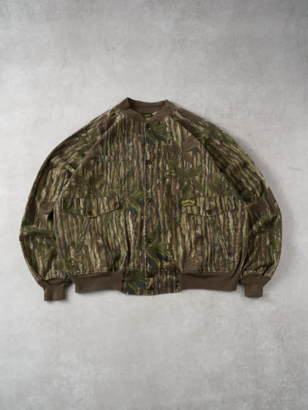 Vintage 90s Mossy Green Realtree Camo Bomber Jacket (L/XL) sold by Rebalance Vintage