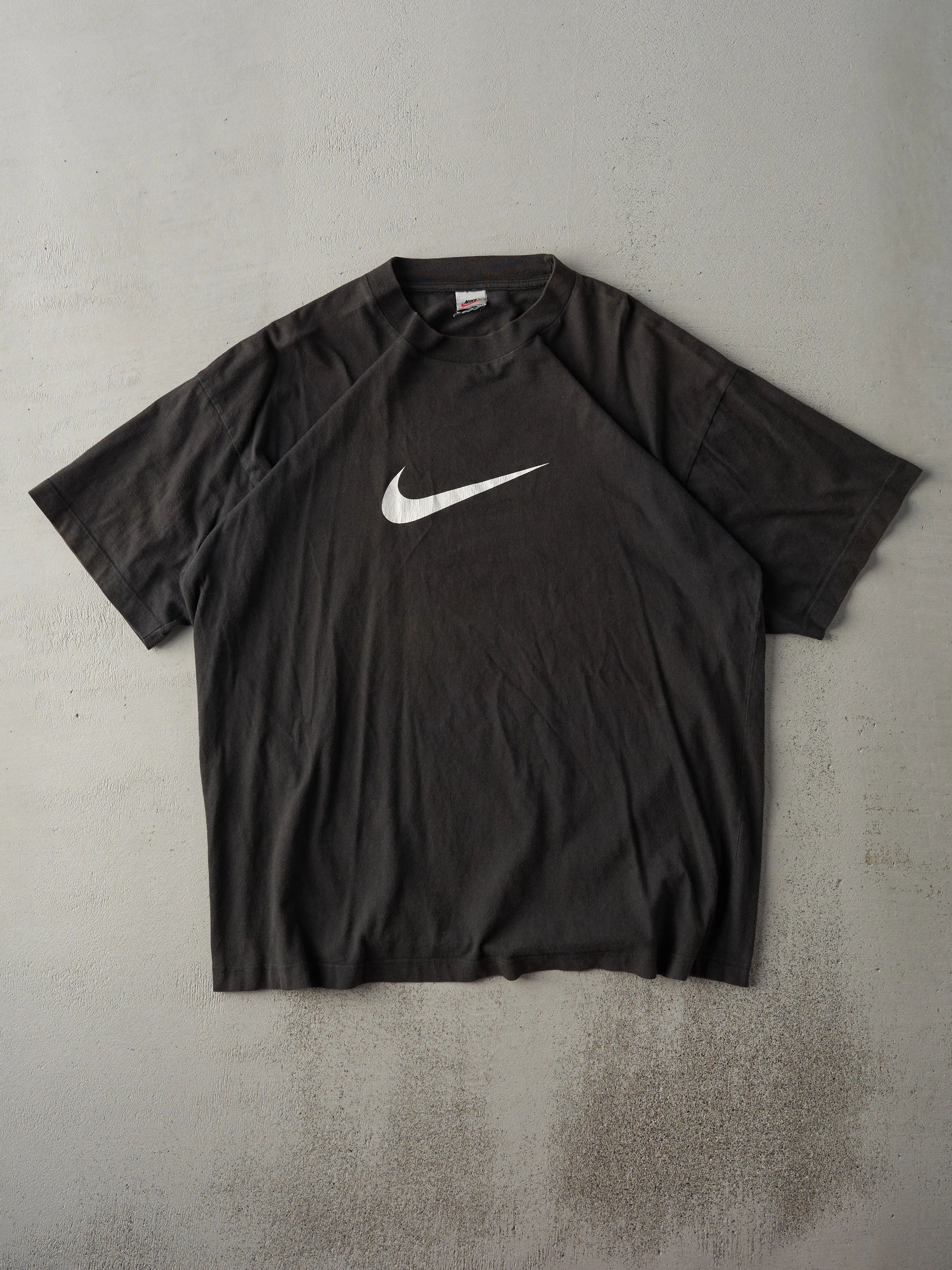Vintage 90s Black Nike Swoosh Tee (L) sold by Rebalance Vintage