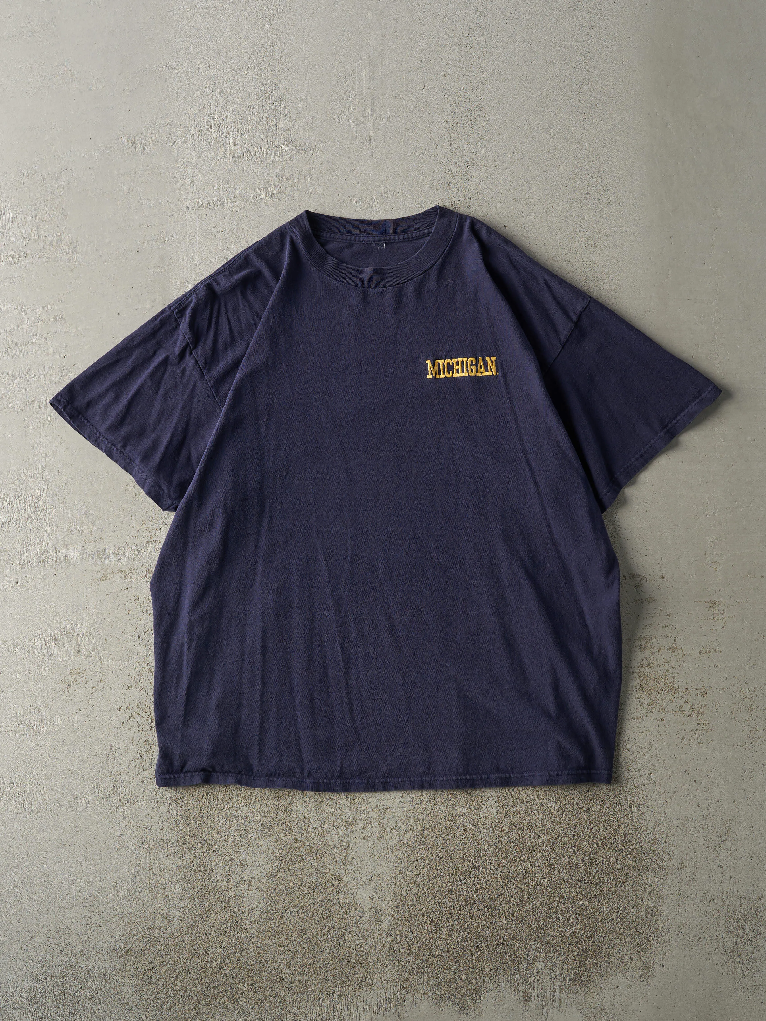 Vintage 90s Navy Blue Embroidered University of Michigan Tee (L) sold by Rebalance Vintage