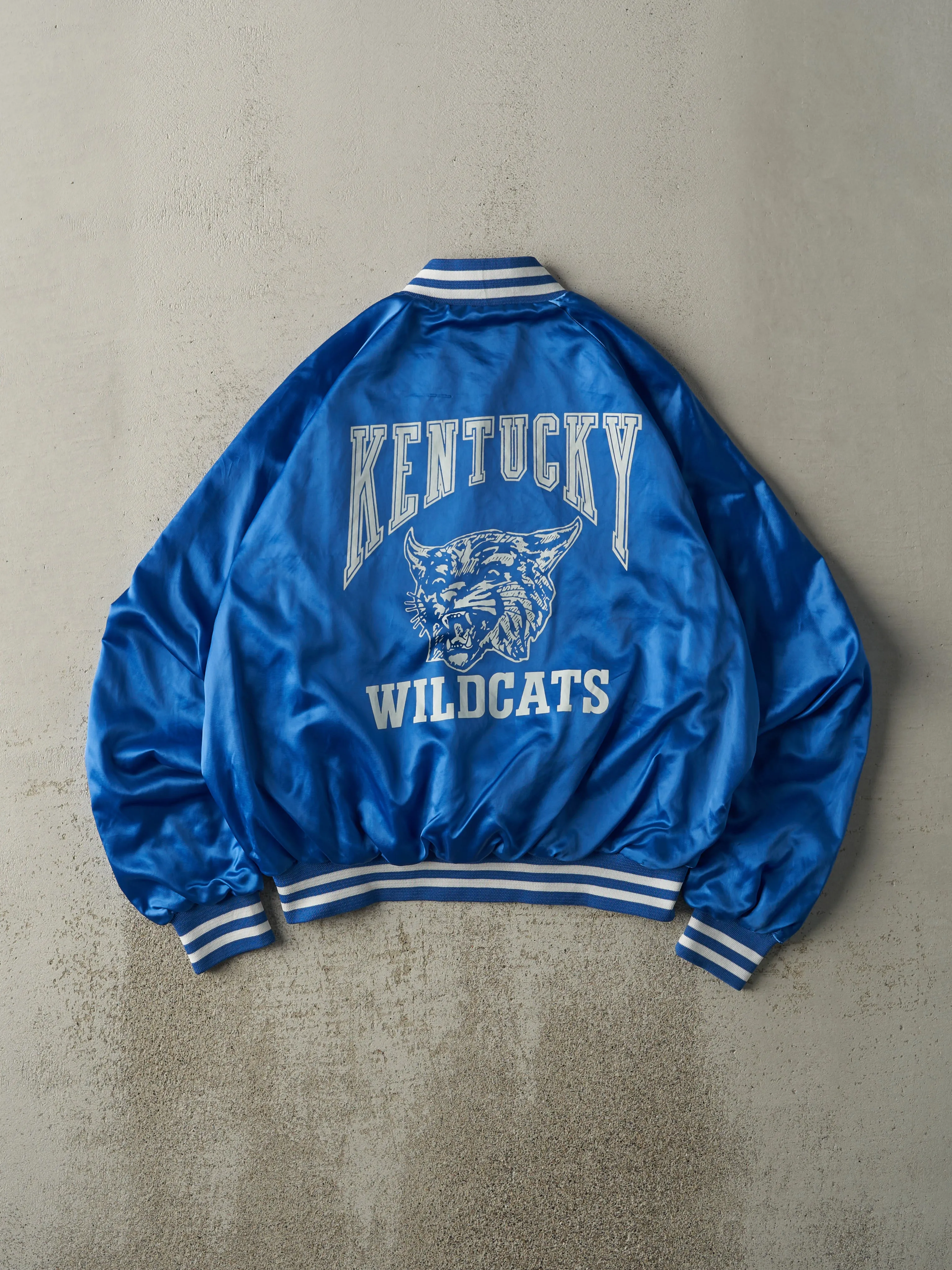 Vintage 80s Blue Kentucky Wildcats Satin Bomber Jacket (L) sold by Rebalance Vintage