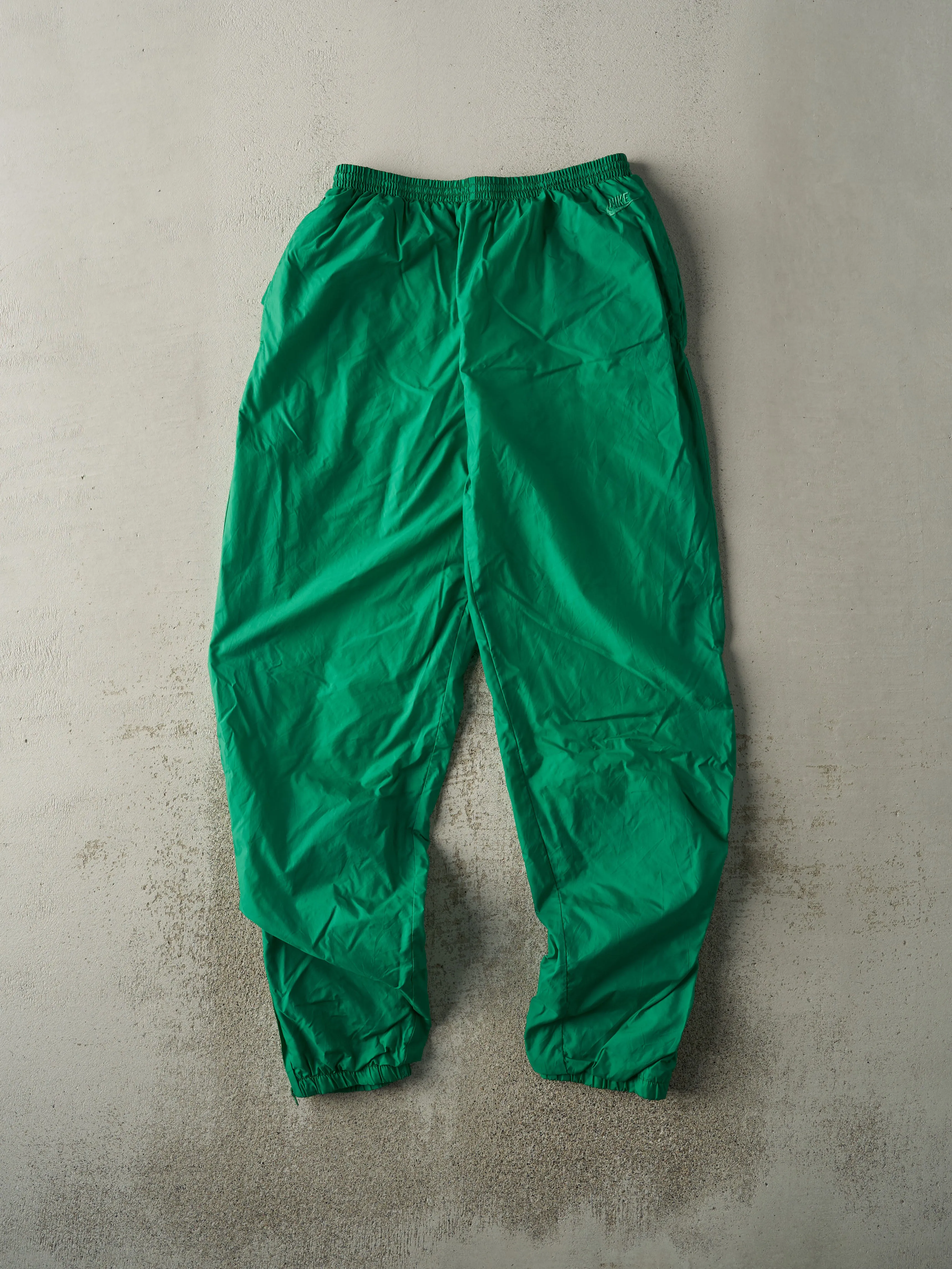 Vintage 90s Green Embroidered Nike Windbreaker Pants (28x32) sold by Rebalance Vintage