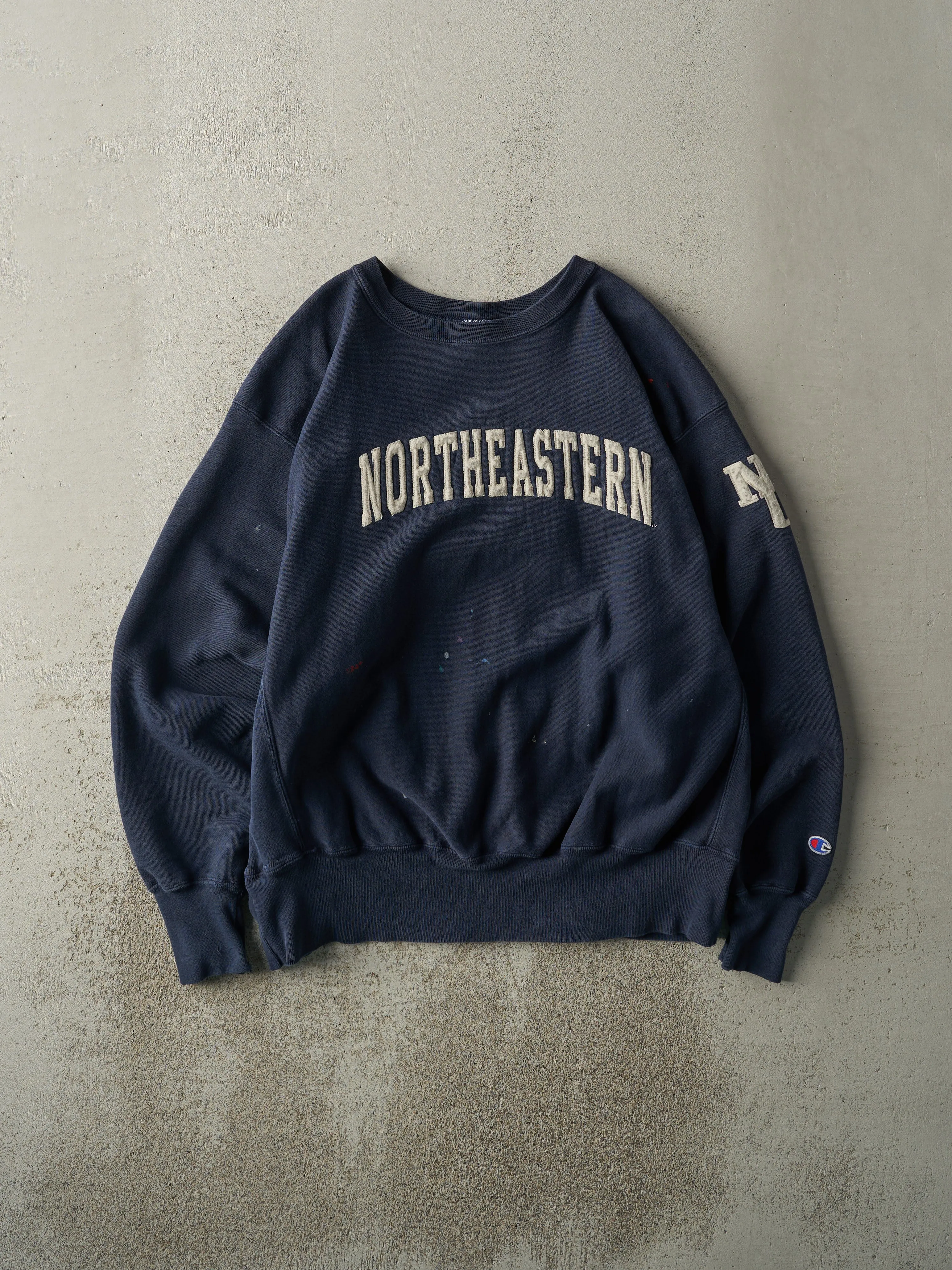 Vintage 90s Navy Northeastern University Champion Reverse Weave Crewneck (L/XL) sold by Rebalance Vintage