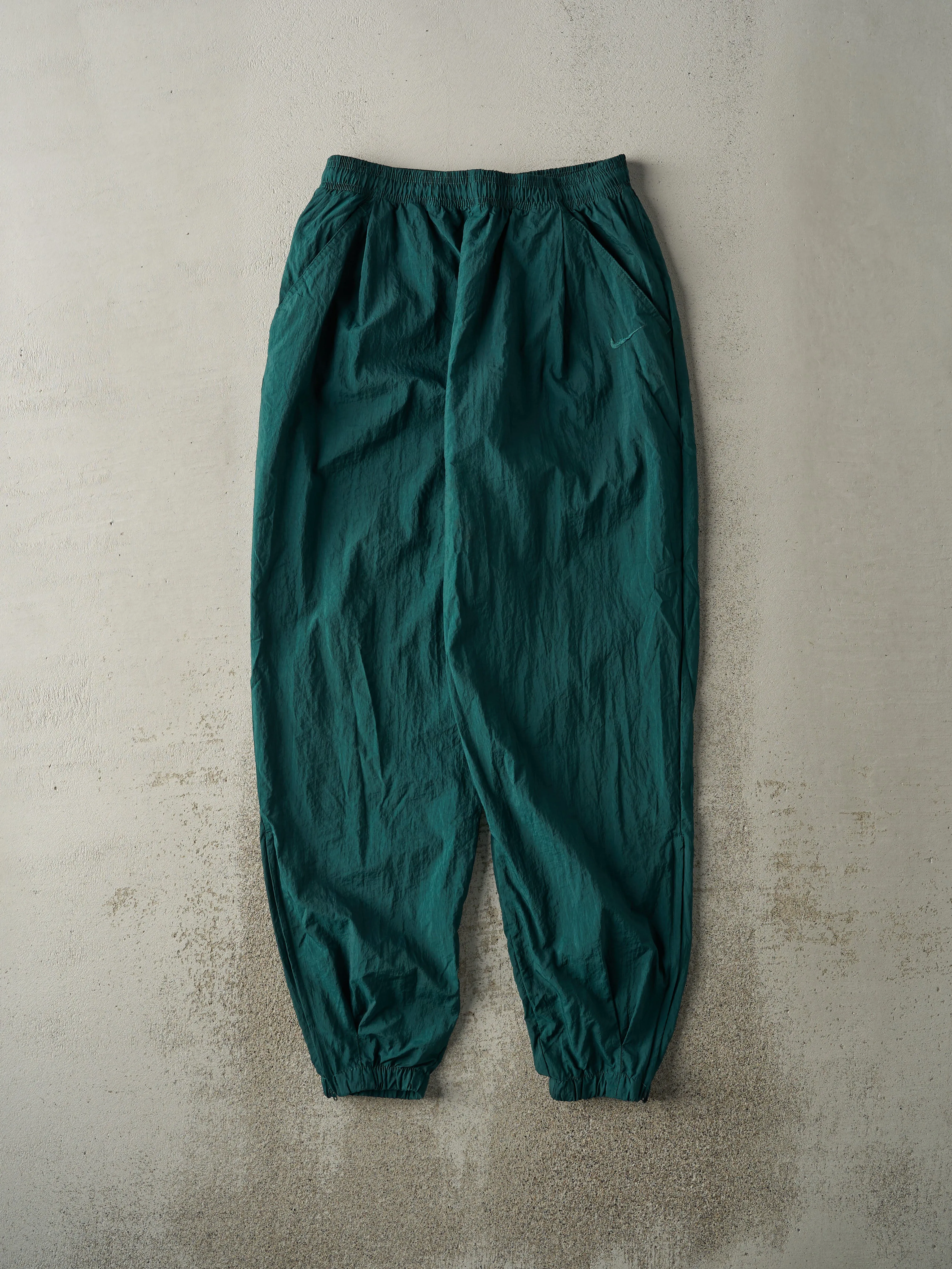 Vintage 90s Green Embroidered Nike Windbreaker Pants (29x32) sold by Rebalance Vintage