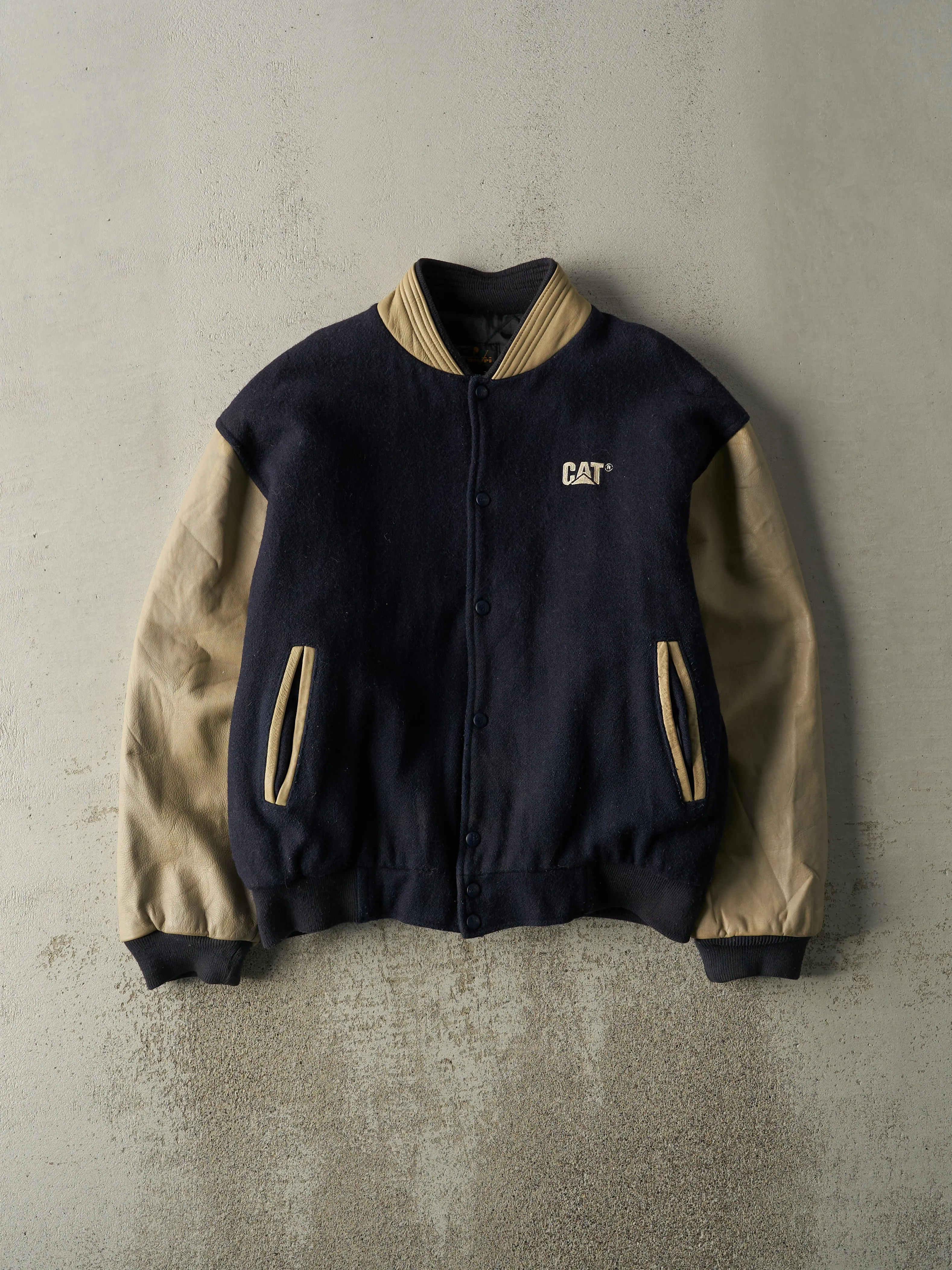 Vintage 90s Navy Blue & Beige CAT Embroidered Varsity Jacket (L) sold by Rebalance Vintage
