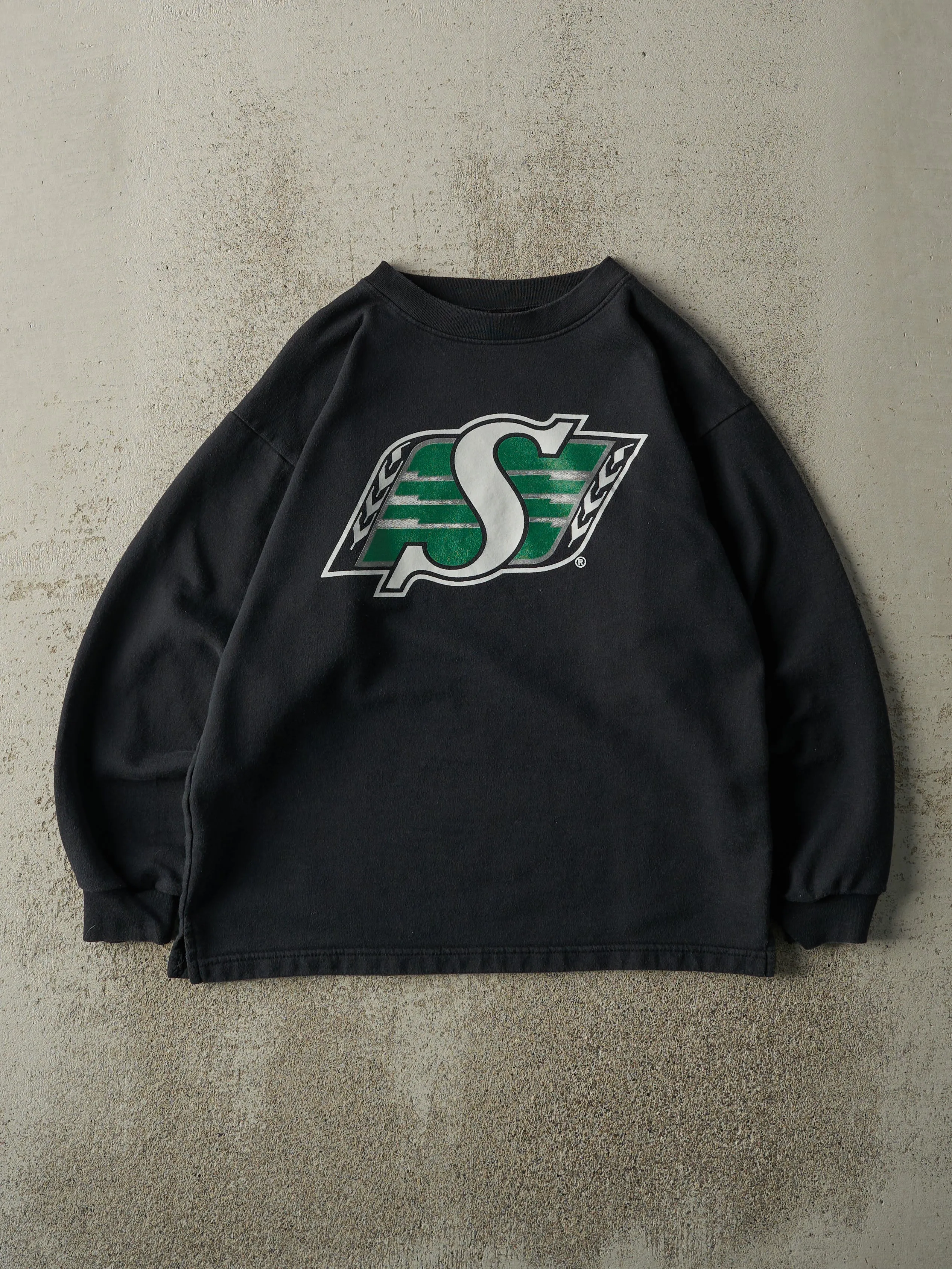Vintage 90s Black Saskatchewan Roughriders CFL Crewneck (S/M) sold by Rebalance Vintage