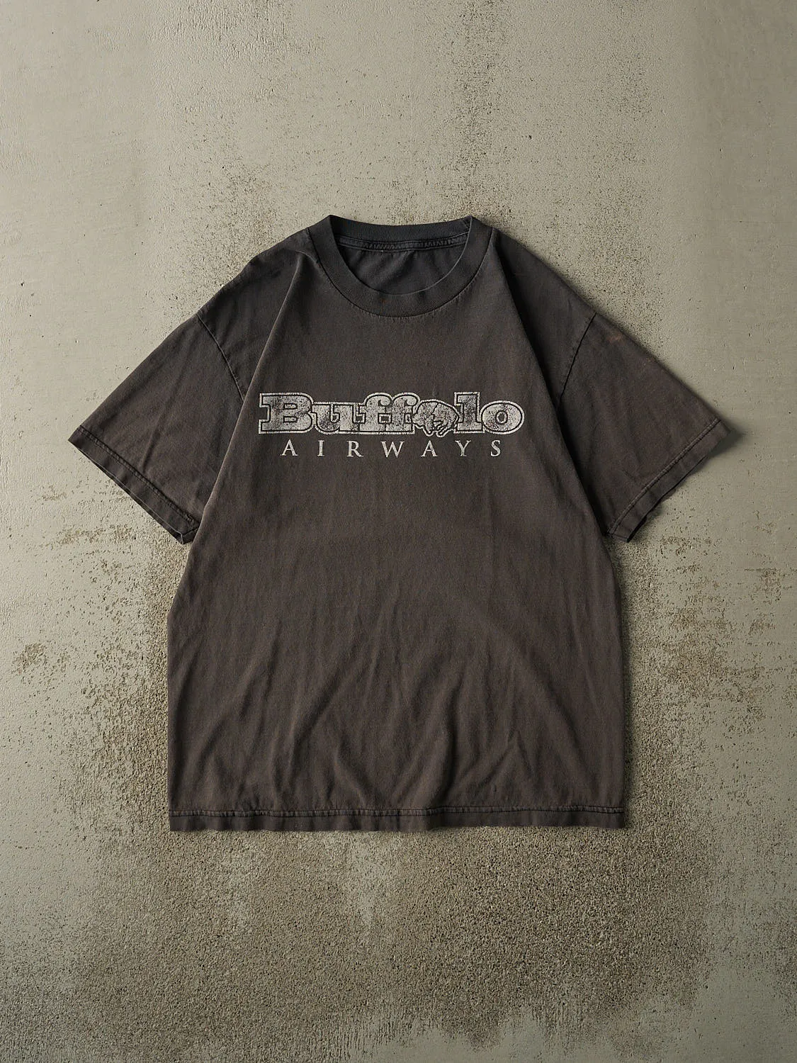 Vintage 90s Faded Black Buffalo Airways Tee (L) sold by Rebalance Vintage