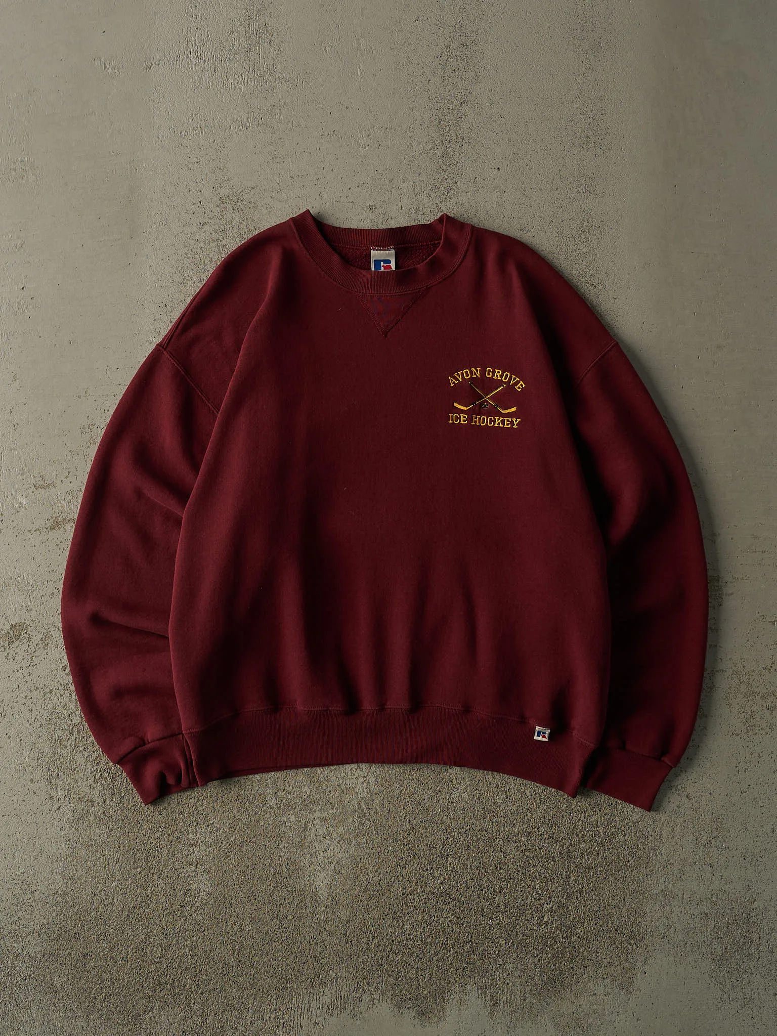 Vintage 90s Burgundy Avon Grove Ice Hockey Embroidered Russell Athletic Crewneck (L/XL) sold by Rebalance Vintage