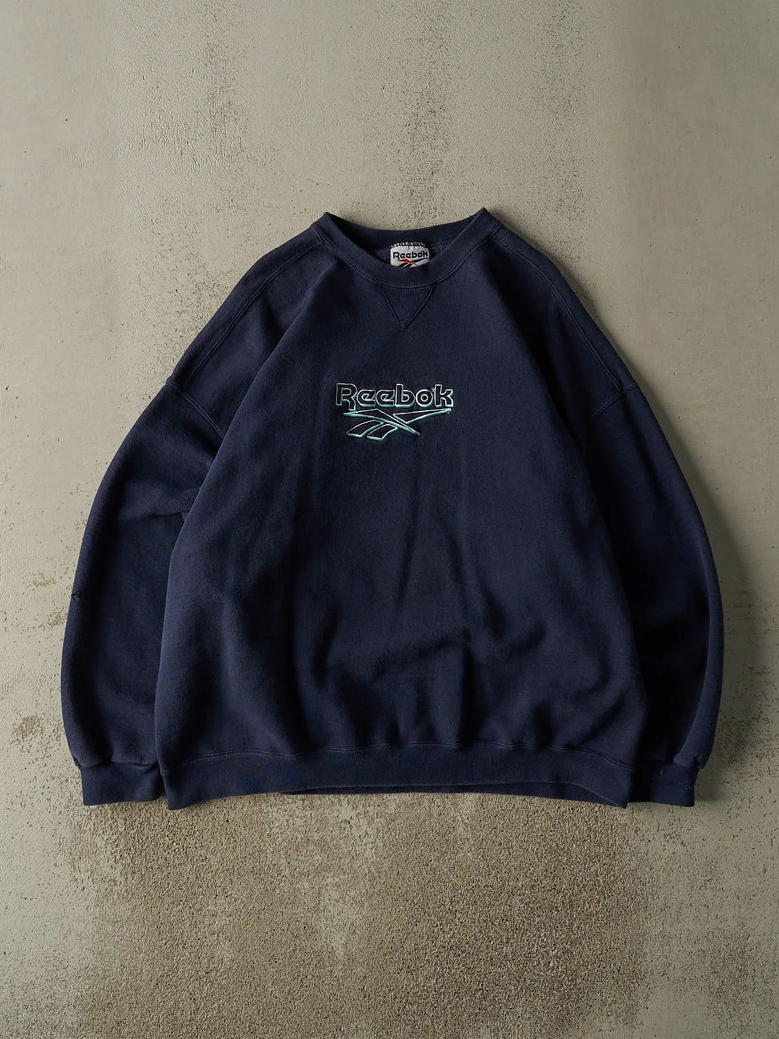 Vintage 90s Navy Blue Reebok Embroidered Crewneck (XL) sold by Rebalance Vintage