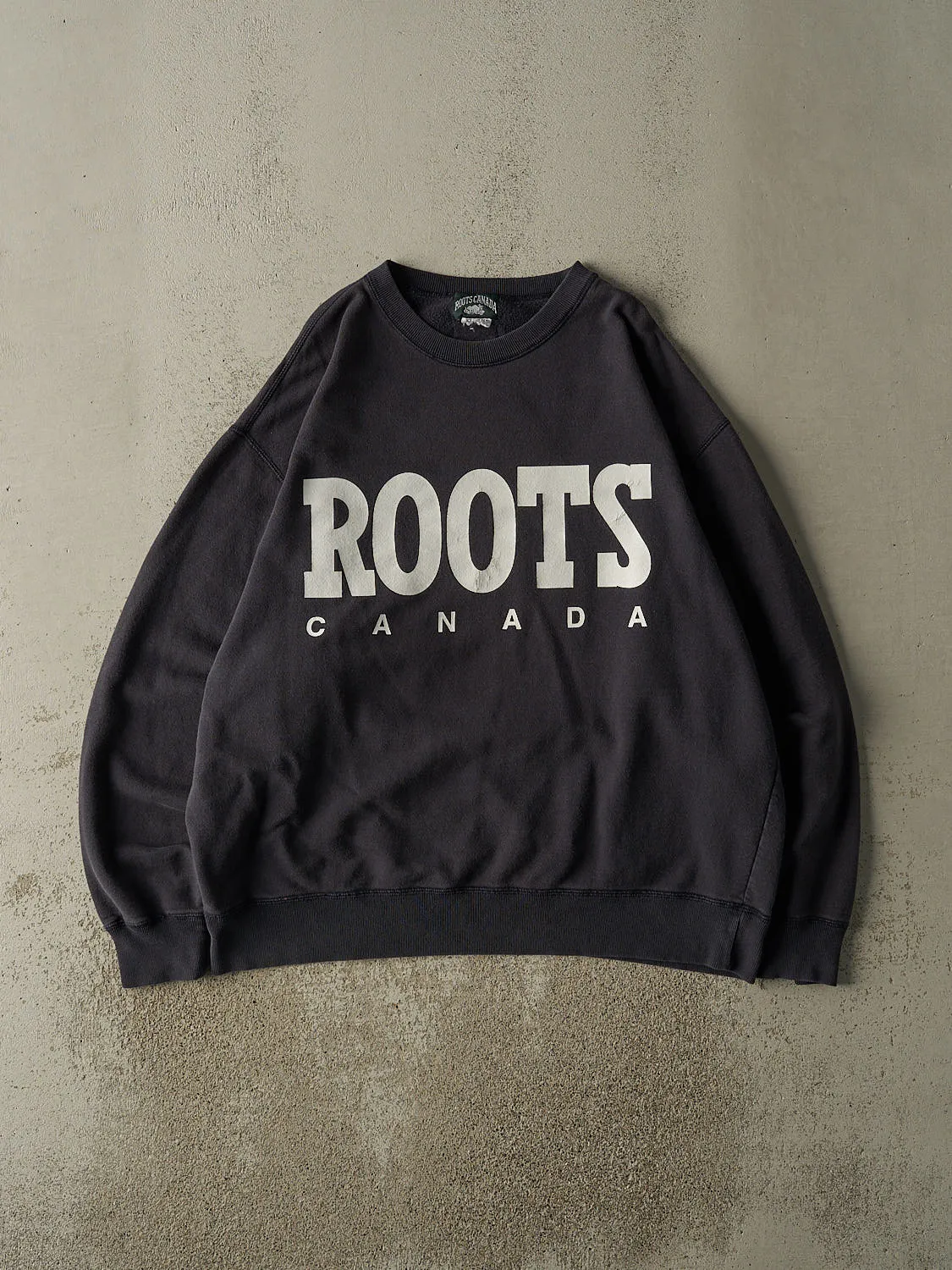 Vintage 90s Sun Faded Navy Roots Canada Logo Crewneck (XL/XXL) sold by Rebalance Vintage