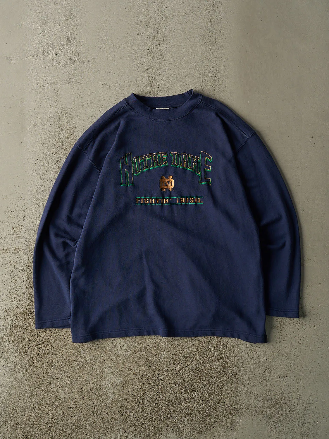 Vintage 90s Navy Blue Notre Dame Fighting Irish Embroidered Crewneck (XL) sold by Rebalance Vintage