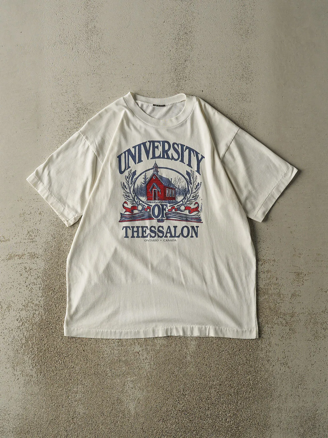Vintage 90s White University of Thessalon Single Stitch Tee (M) sold by Rebalance Vintage