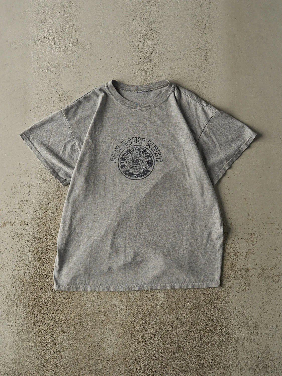 Vintage 90s Grey BUM Equipment Tee (L) sold by Rebalance Vintage