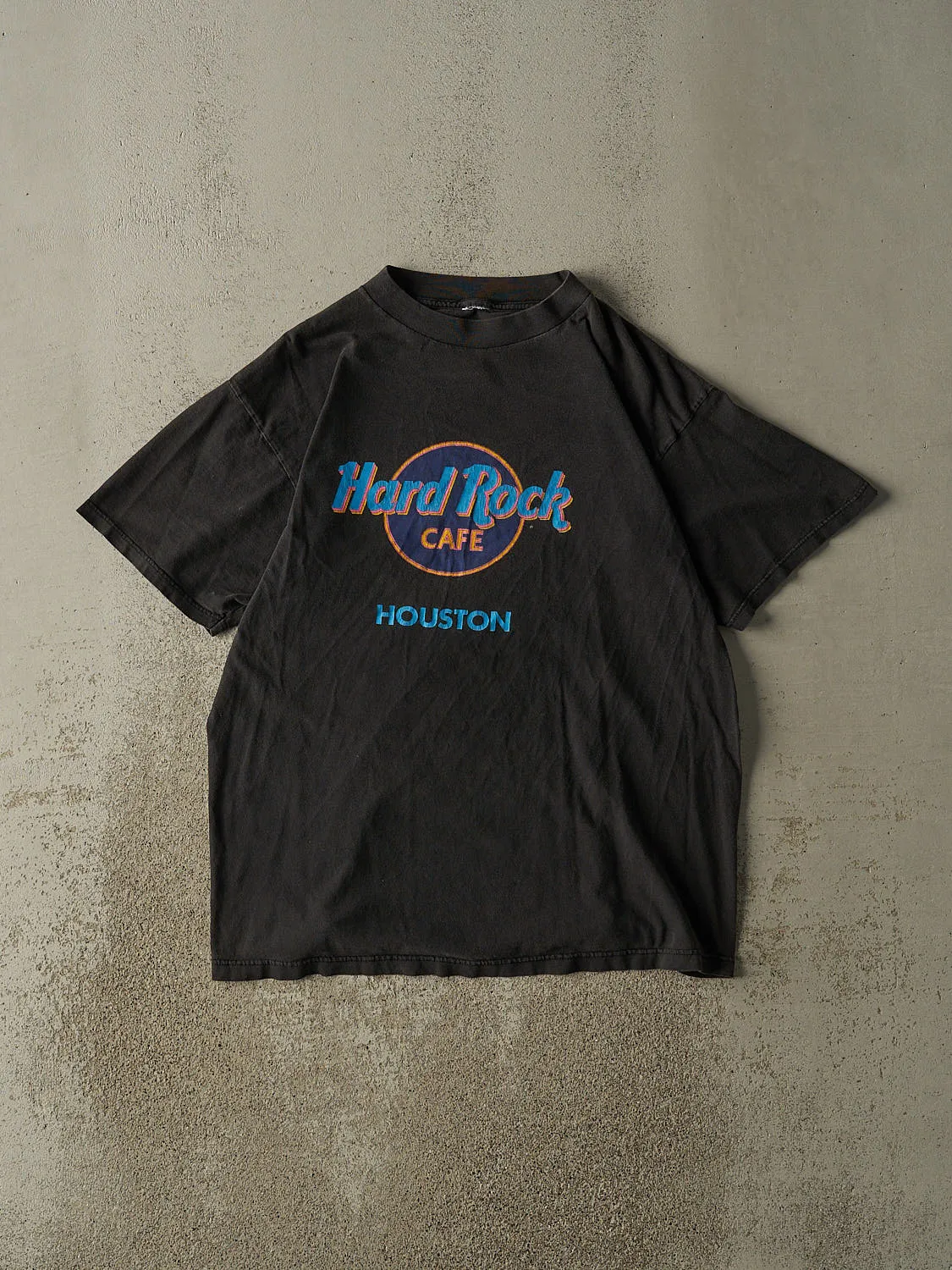 Vintage 90s Faded Black Hard Rock Cafe Houston Tee (L) sold by Rebalance Vintage