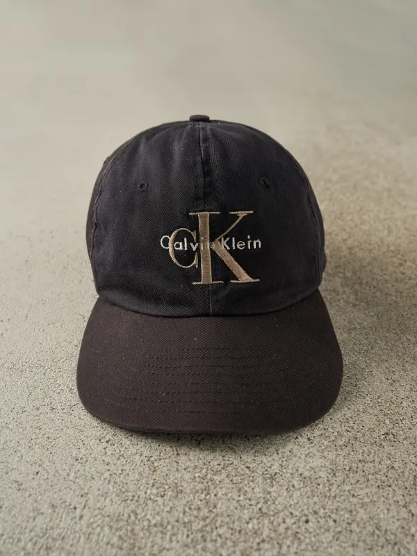 Vintage 90s Faded Black Calvin Klein Embroidered Strapback (O/S) sold by Rebalance Vintage