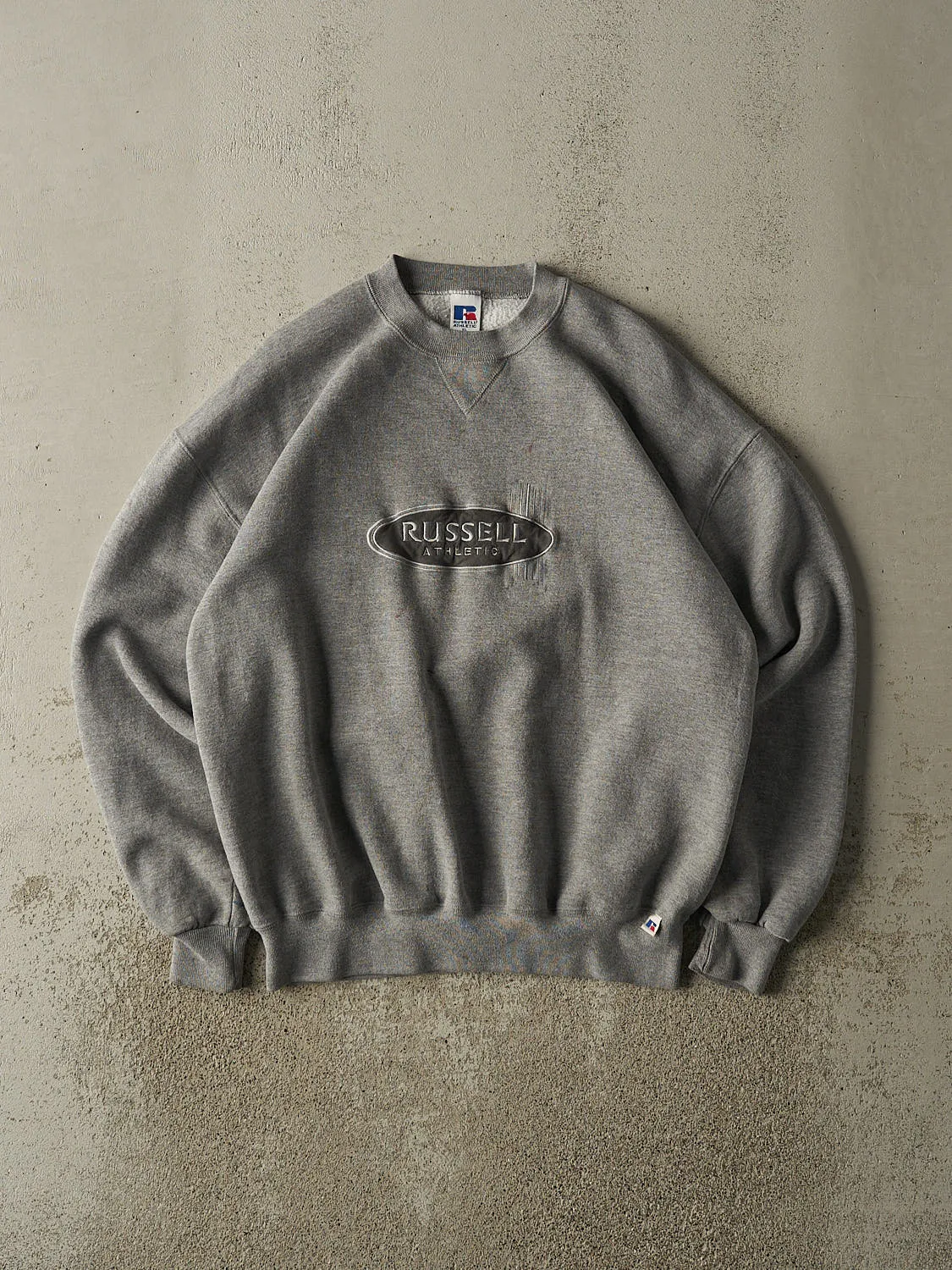 Vintage 90s Grey Russell Athletic Embroidered Logo Crewneck (L/XL) sold by Rebalance Vintage