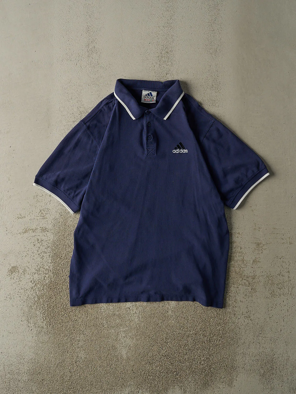 Vintage 90s Navy Blue Adidas Embroidered Quarter Button Tee (L/XL) sold by Rebalance Vintage