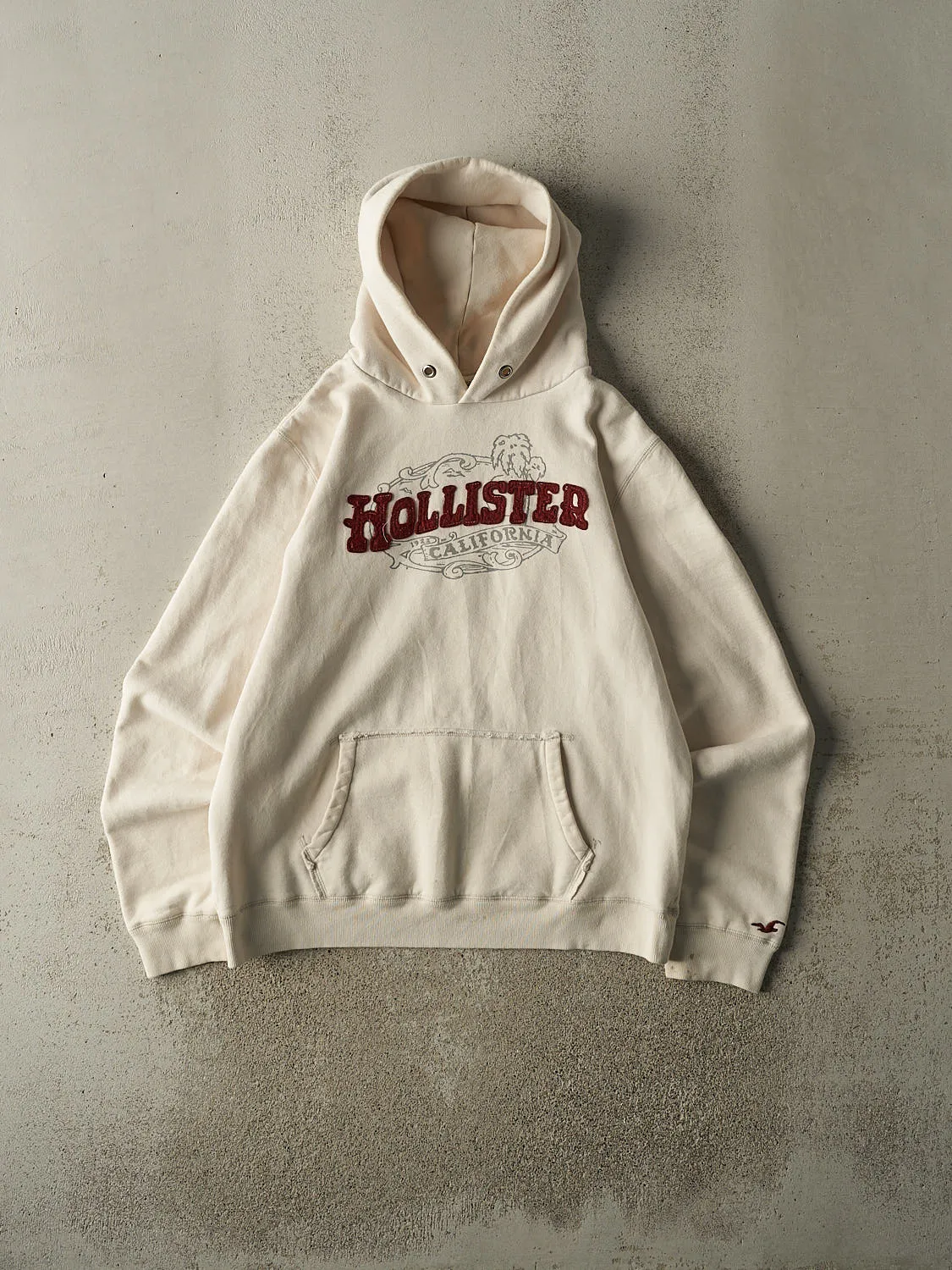 Vintage Y2K Beige Hollister Embroidered Hoodie (M) sold by Rebalance Vintage