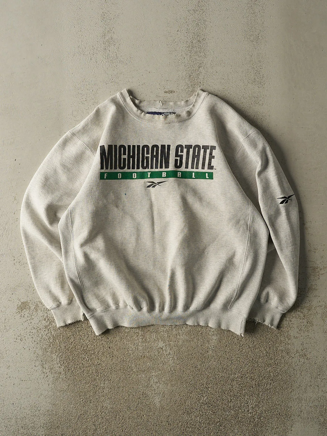 Vintage 90s Heather Grey Reebok Michigan State Football Crewneck (L/XL) sold by Rebalance Vintage