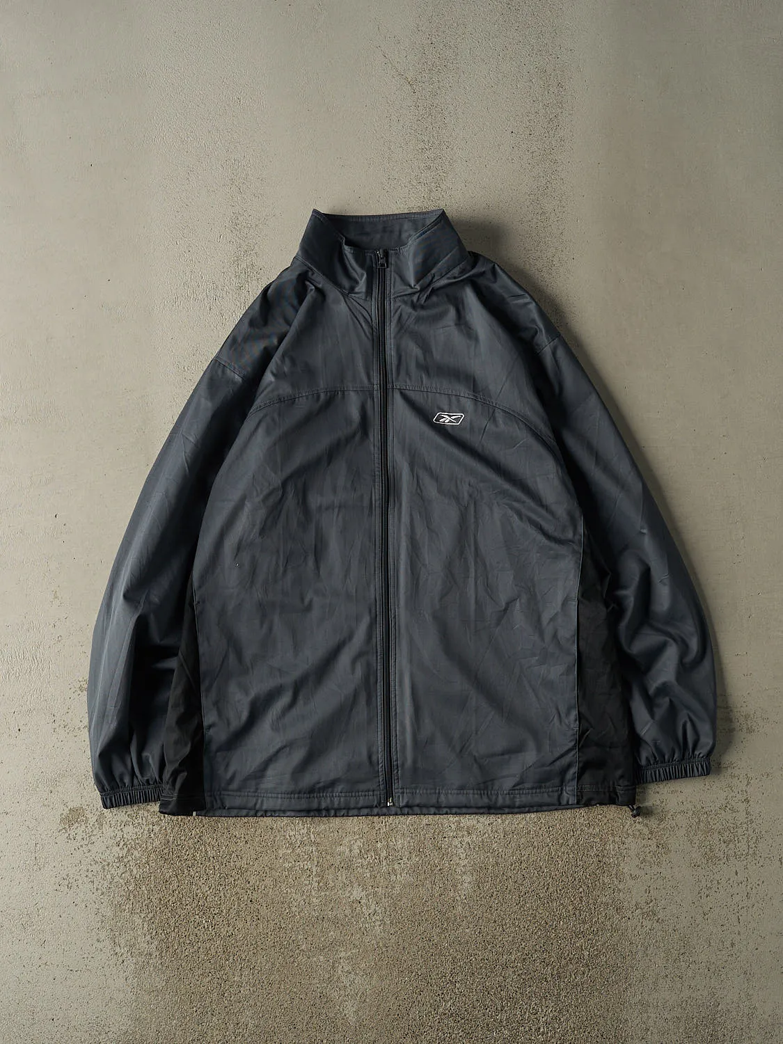 Vintage Y2K Charcoal Grey Reebok Windbreaker Jacket (XXL) sold by Rebalance Vintage