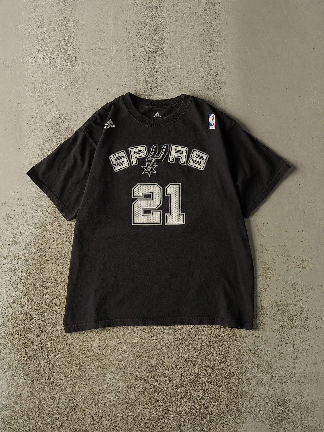 Vintage Y2K Black San Antonio Spurs #21 Tim Duncan Tee (L) sold by Rebalance Vintage