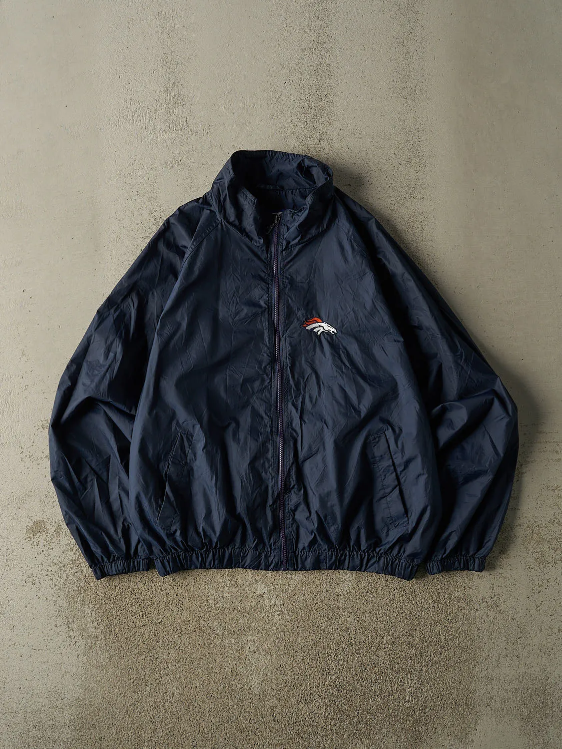 Vintage 90s Navy Blue Denver Broncos Windbreaker Jacket (L/XL) sold by Rebalance Vintage