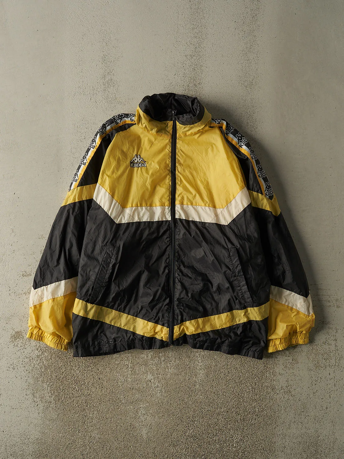 Vintage 90s Black & Yellow Kappa Windbreaker Jacket (L/XL) sold by Rebalance Vintage